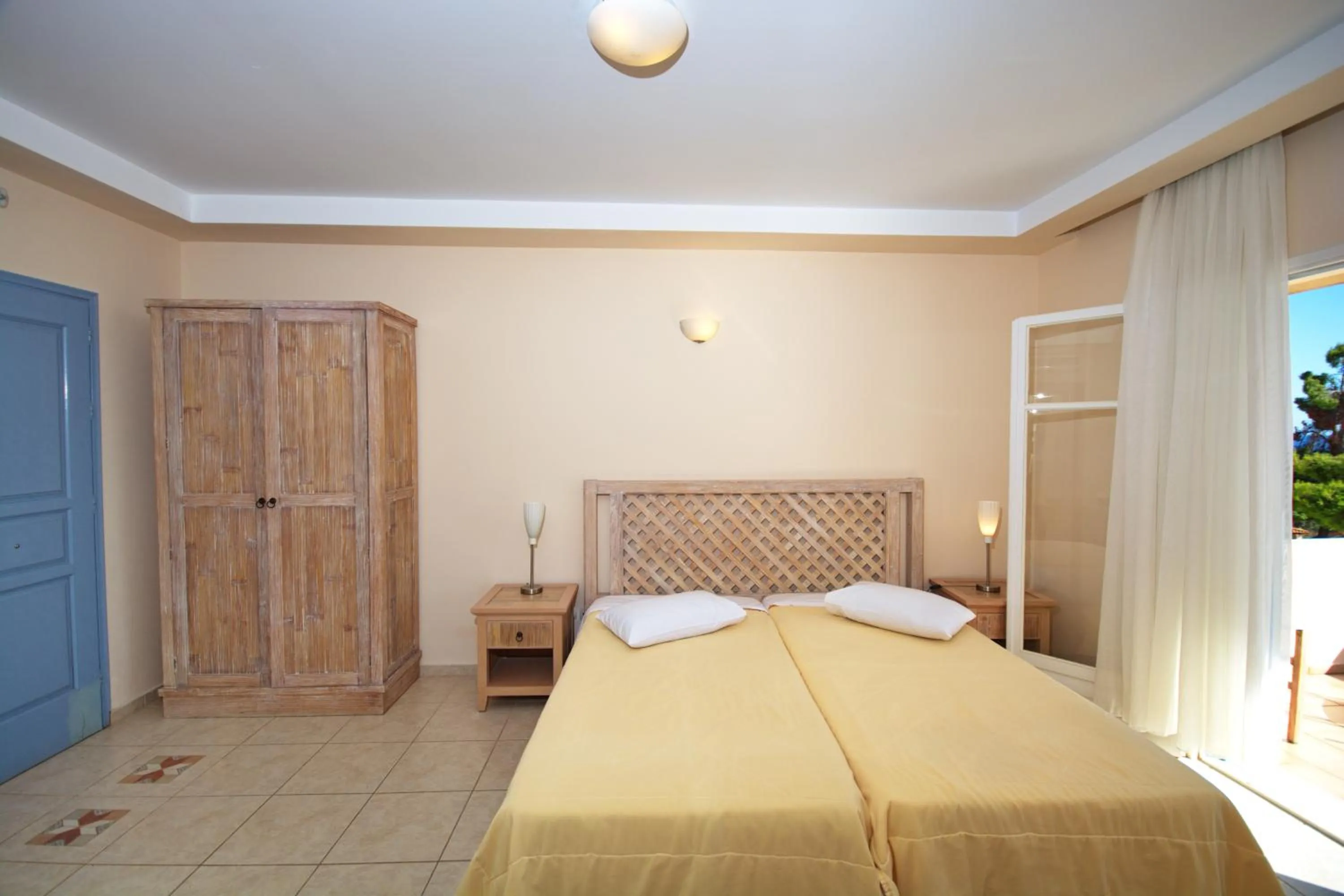Bed in Alonissos Beach Bungalows And Suites Hotel