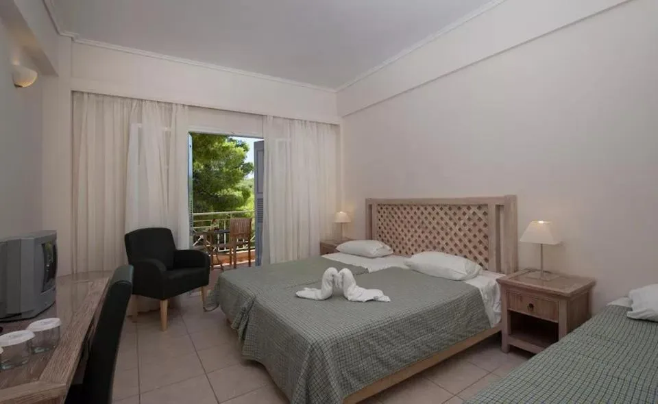 Bed in Alonissos Beach Bungalows And Suites Hotel