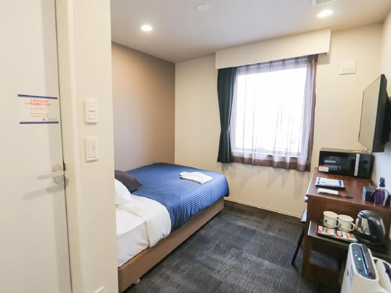 Bed in HOTEL LiVEMAX Aichi Toyota Ekimae