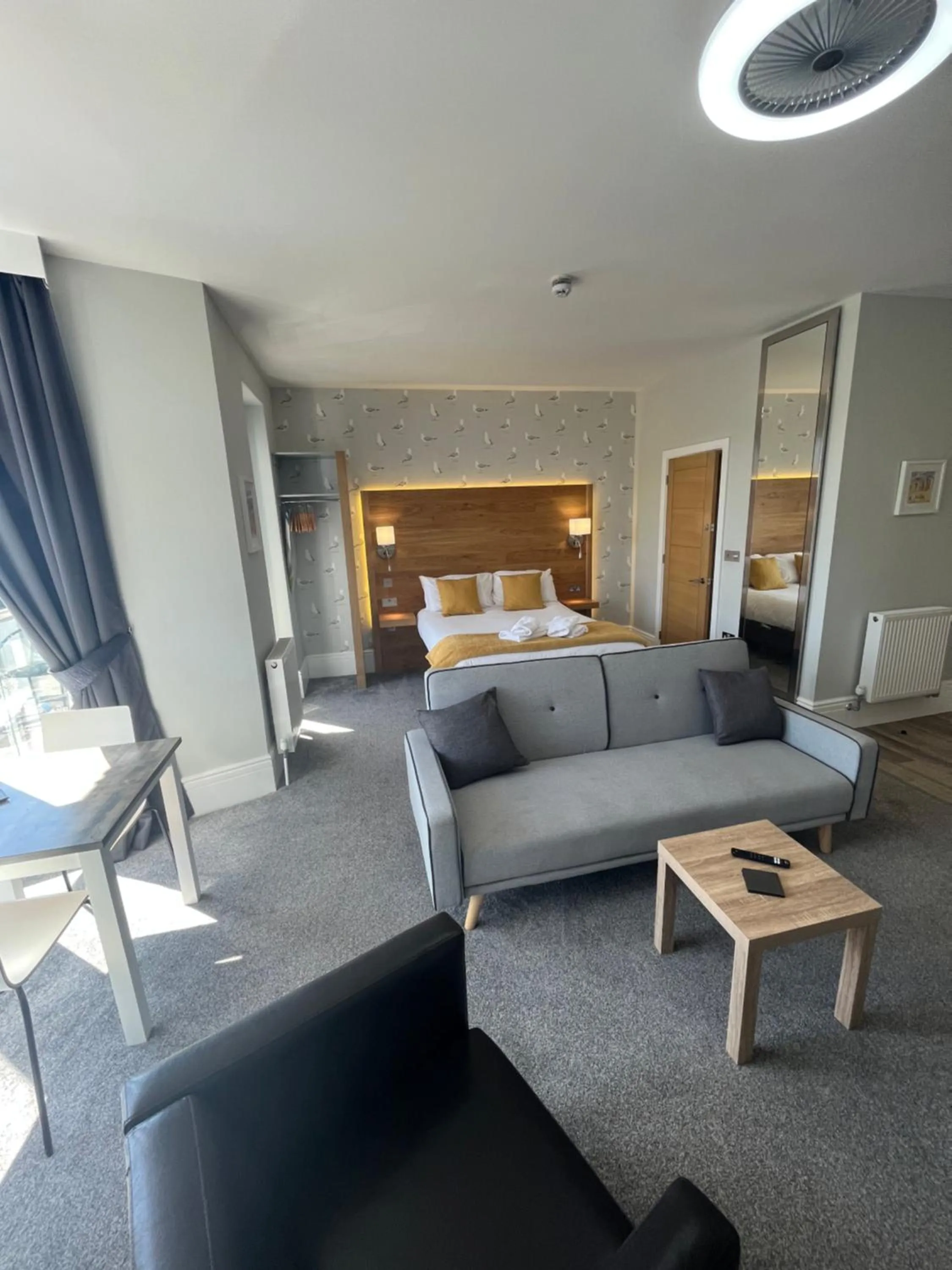 Seating area, Bed in Harmony Apartments