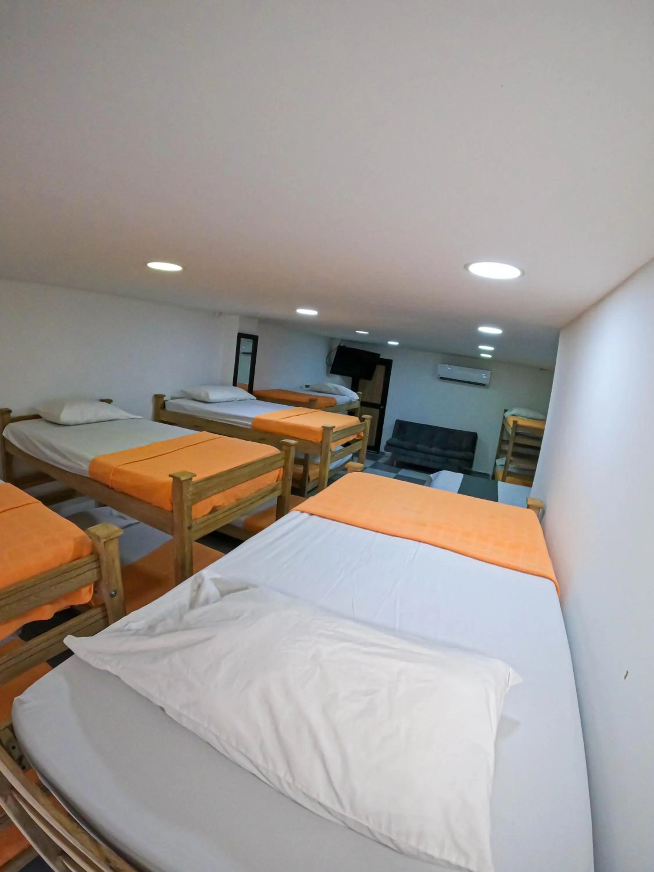 Communal lounge/ TV room, Bed in Hotel El Olimpo