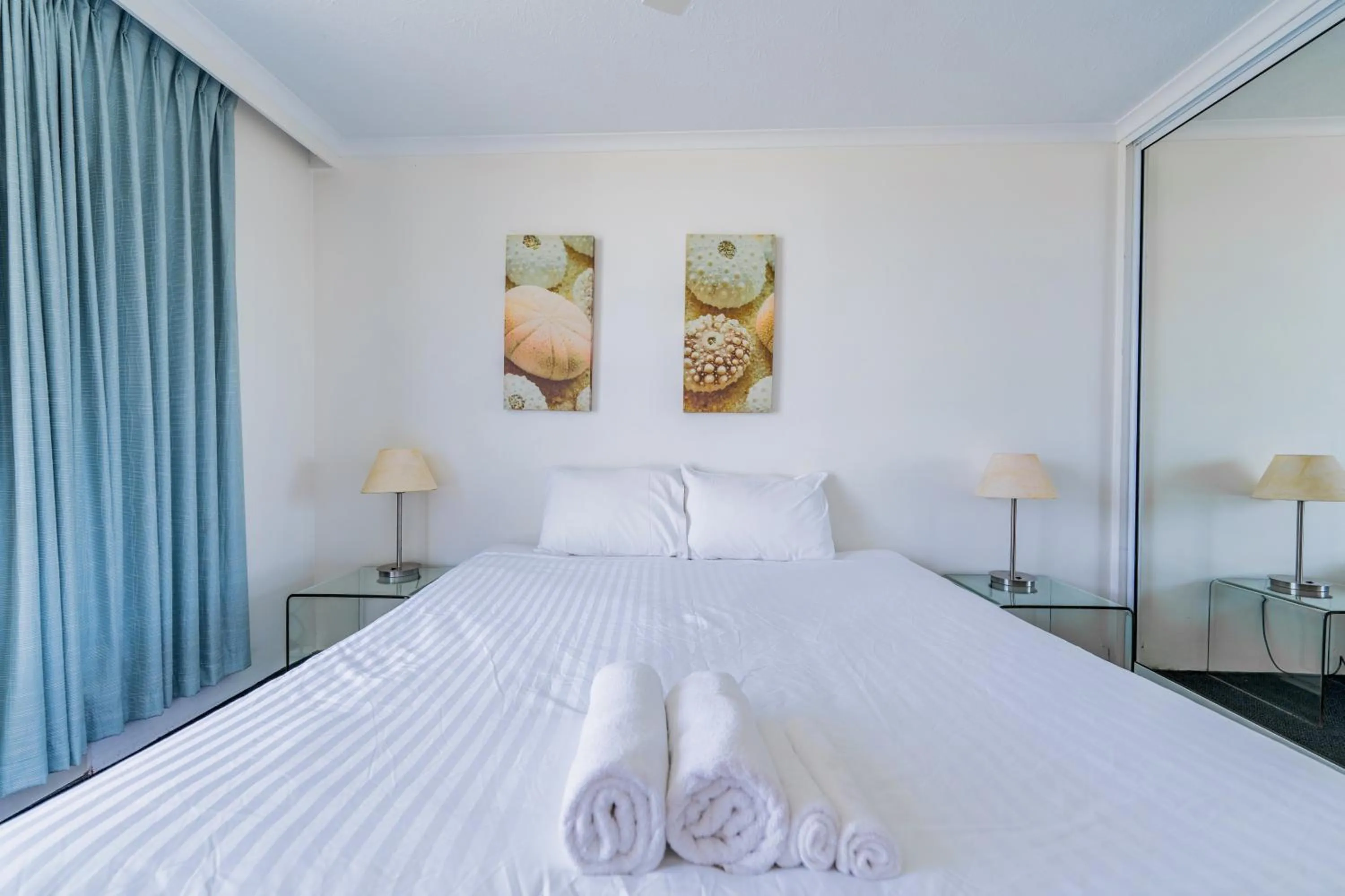 Bed in Olympus Beachfront Apartments