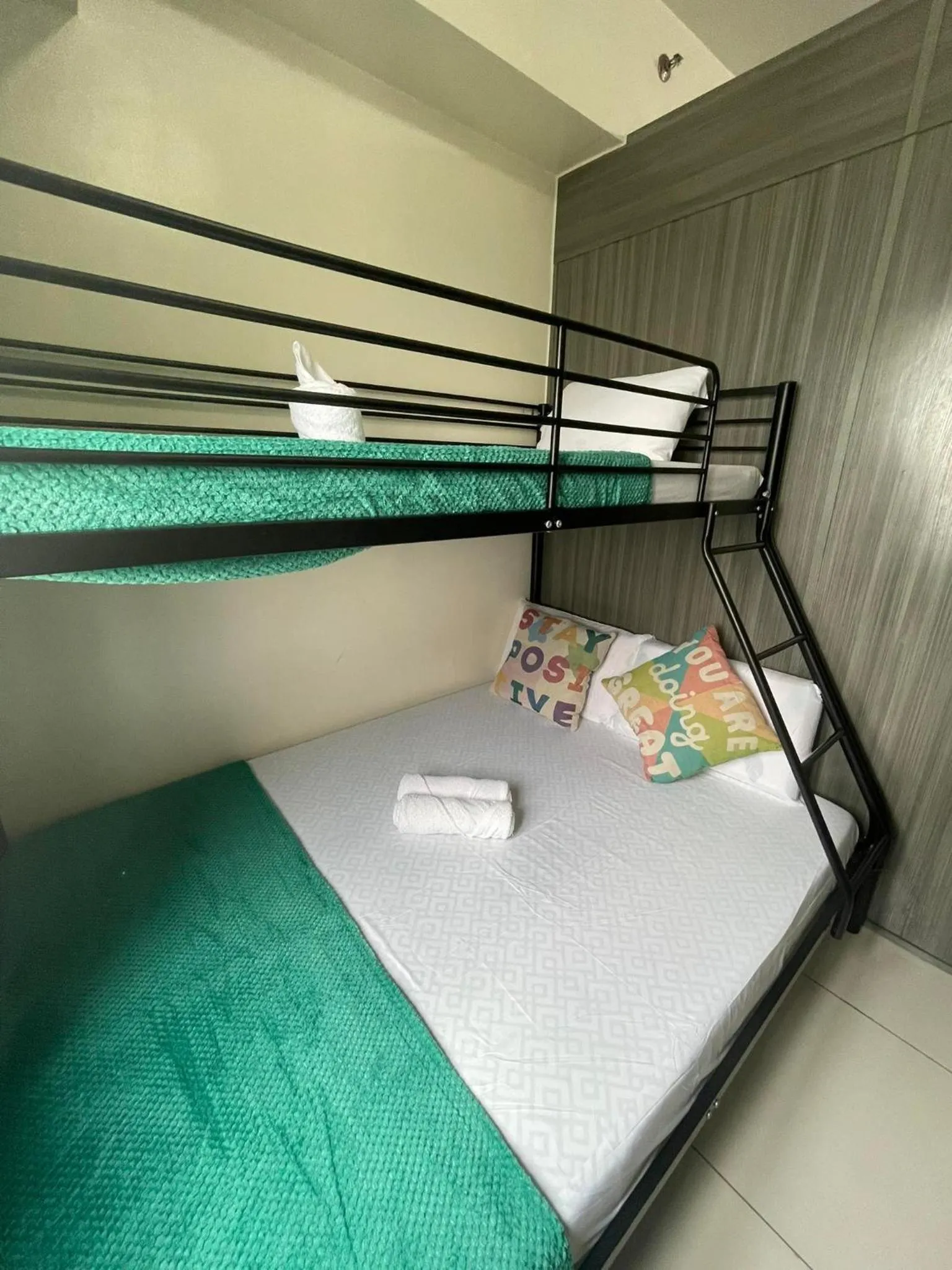 Bed in Green Residences Stays by PBYY