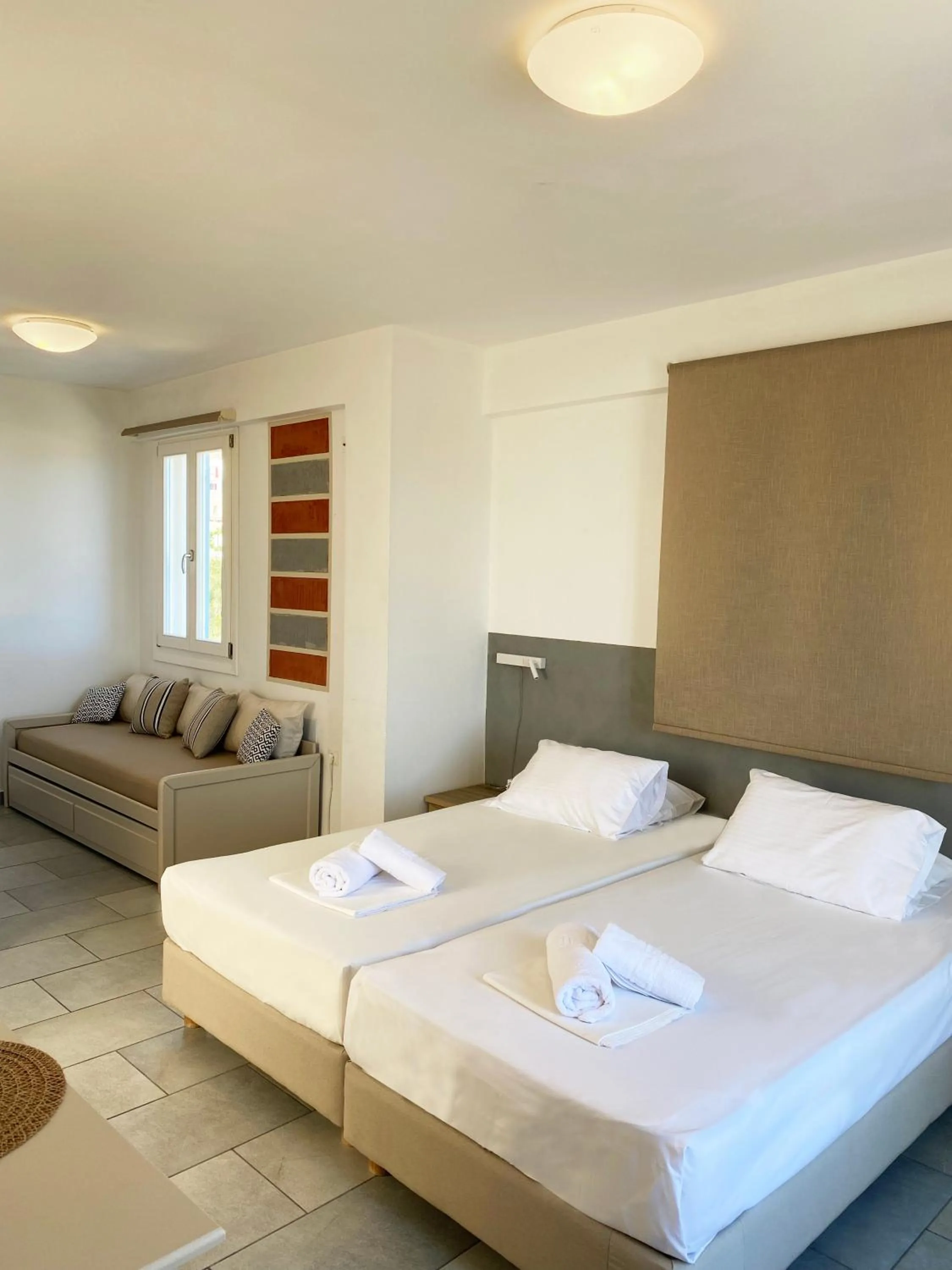 Bed in Agnadi Syros Beachfront Studios & Rooms
