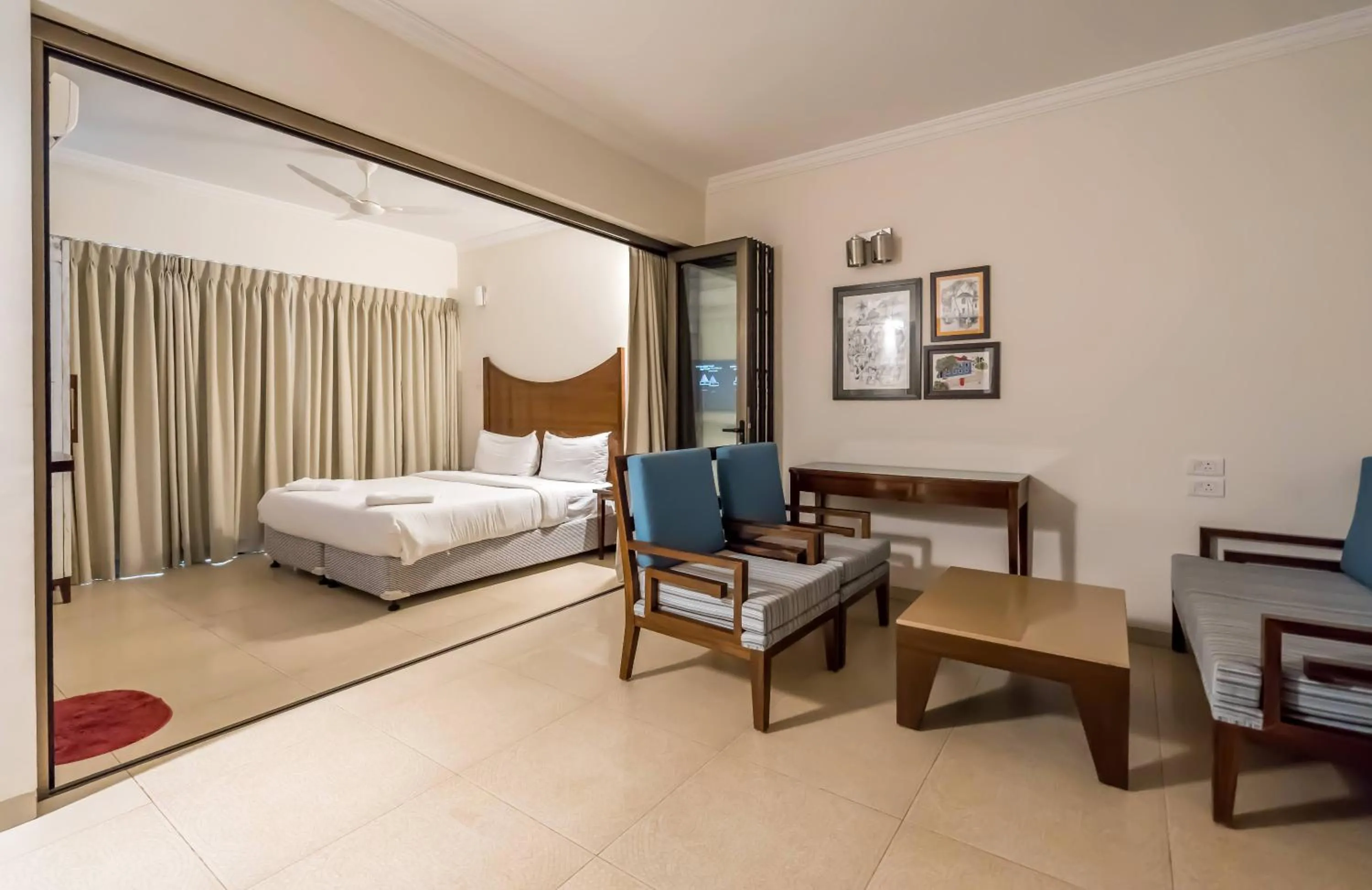 Seating area, Bed in Casa Legend Suites Candolim Goa