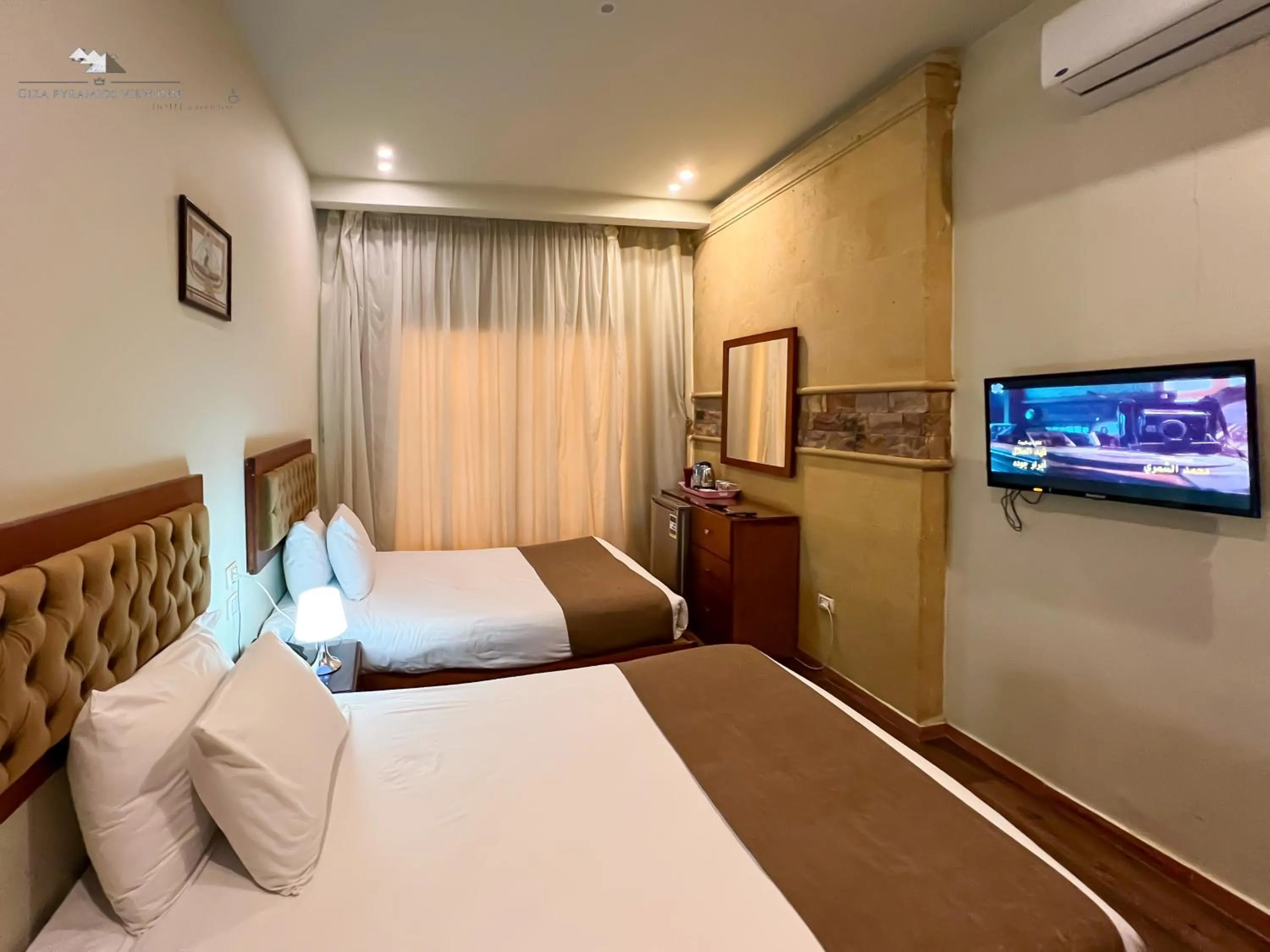 Communal lounge/ TV room, Bed in Giza Pyramids View Inn