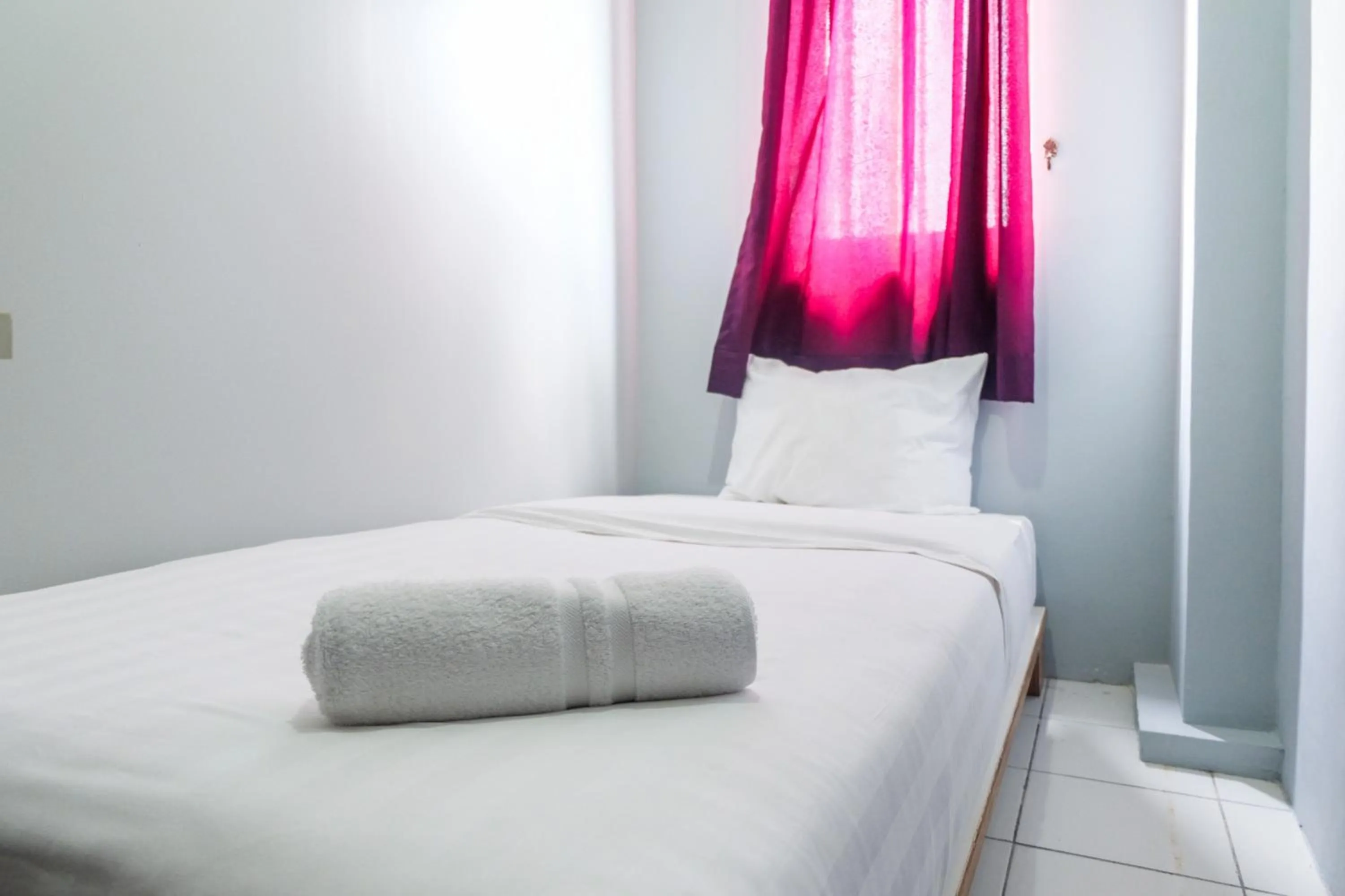 Bed in Best Price and Minimalist 2BR Kebagusan City Apartment By Travelio