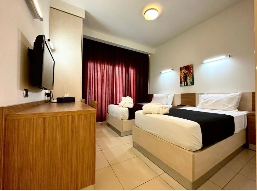 Communal lounge/ TV room, Bed in Hayali Suites