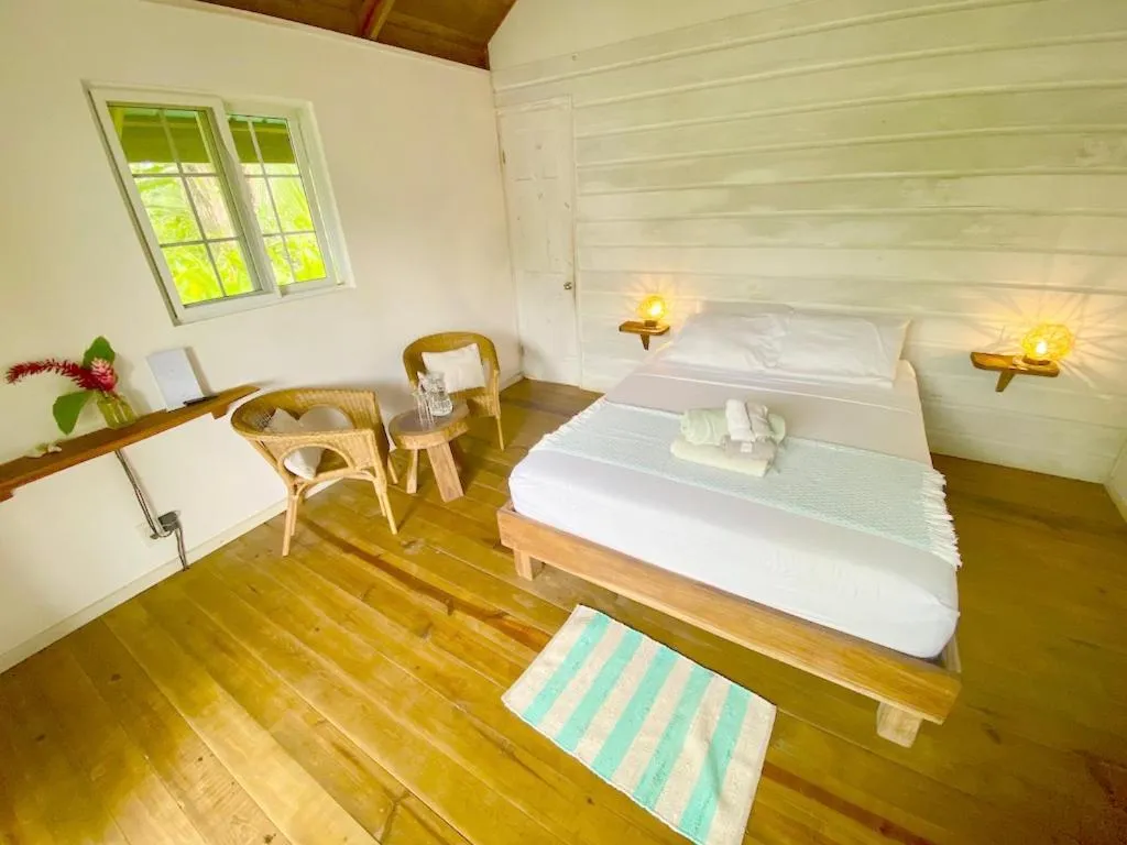 Bed in Bird Island Bungalows