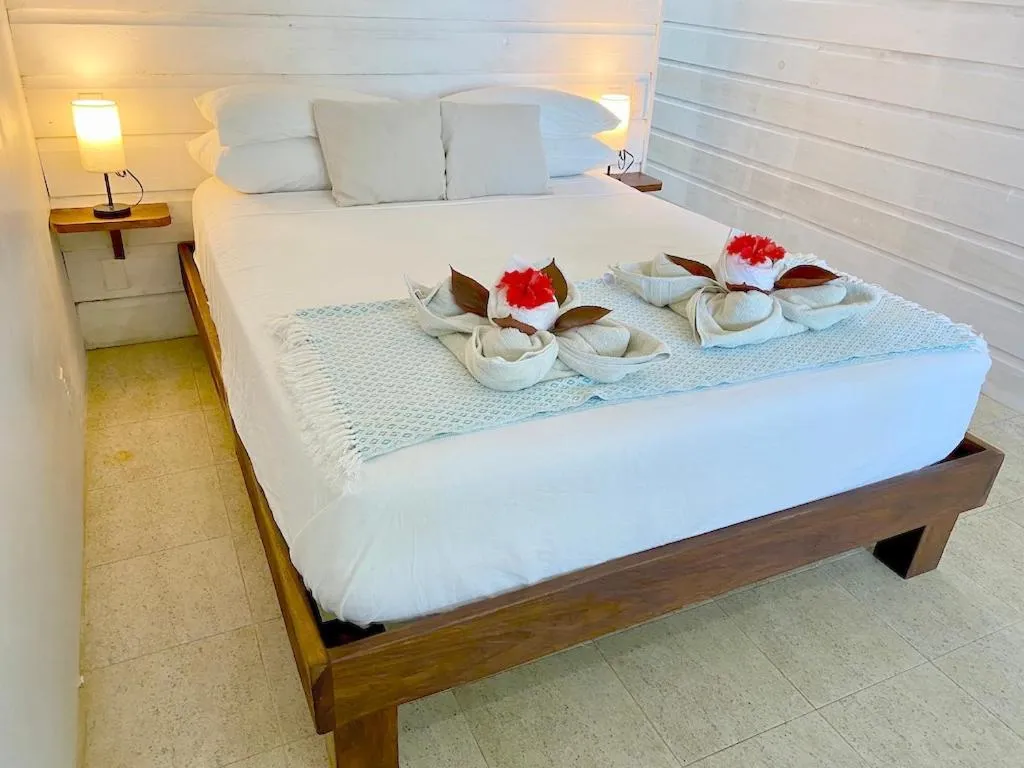 Photo of the whole room, Bed in Bird Island Bungalows