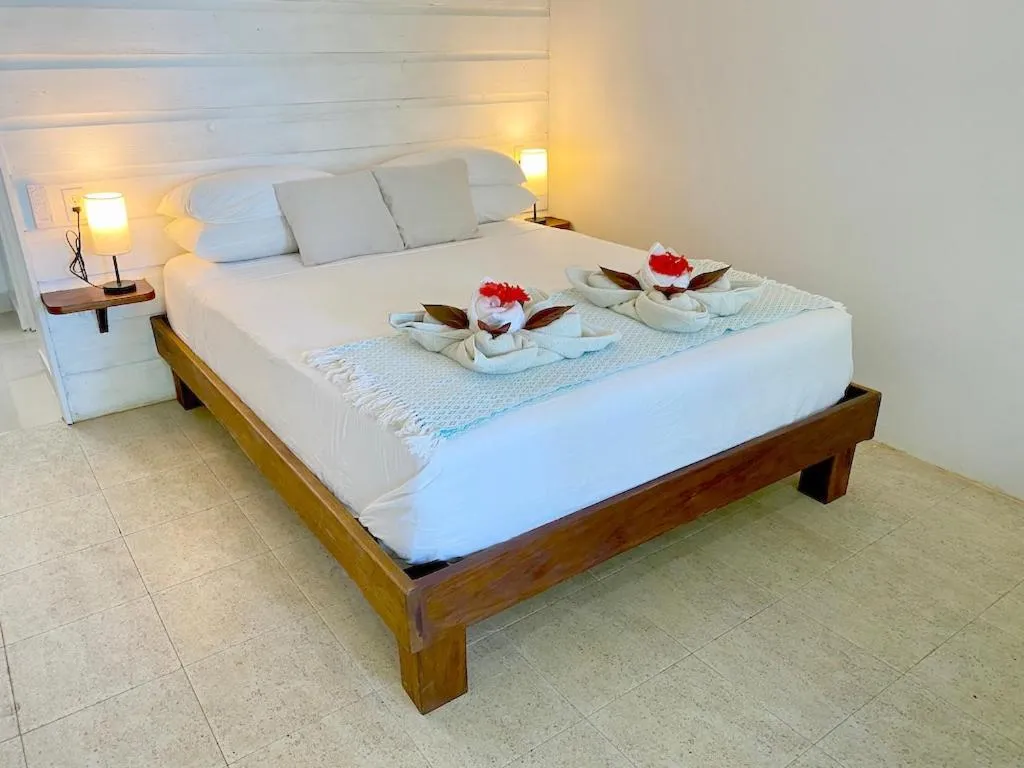Bed in Bird Island Bungalows