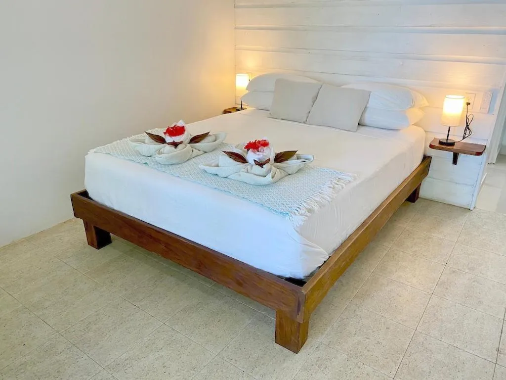 Bed in Bird Island Bungalows