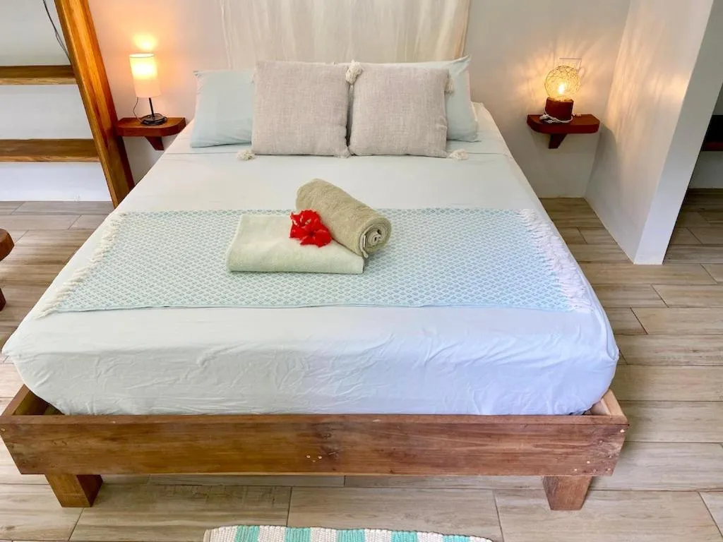 Bed in Bird Island Bungalows