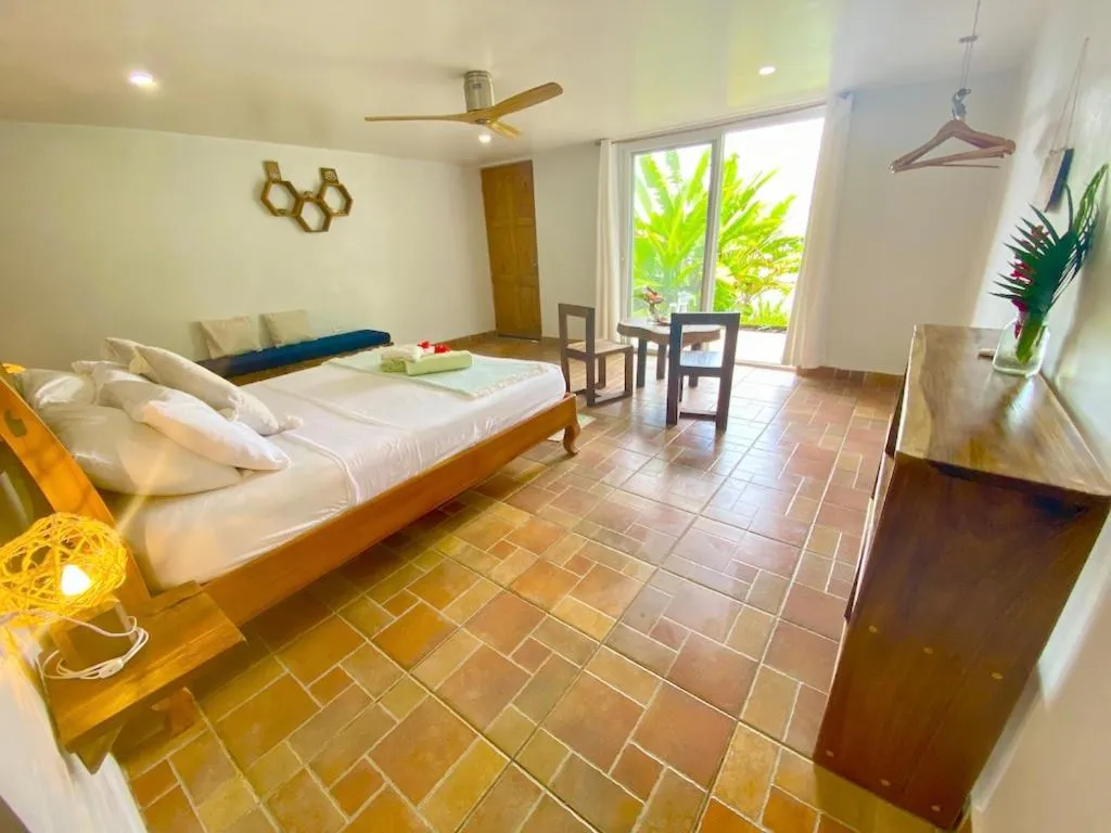 Bed in Bird Island Bungalows