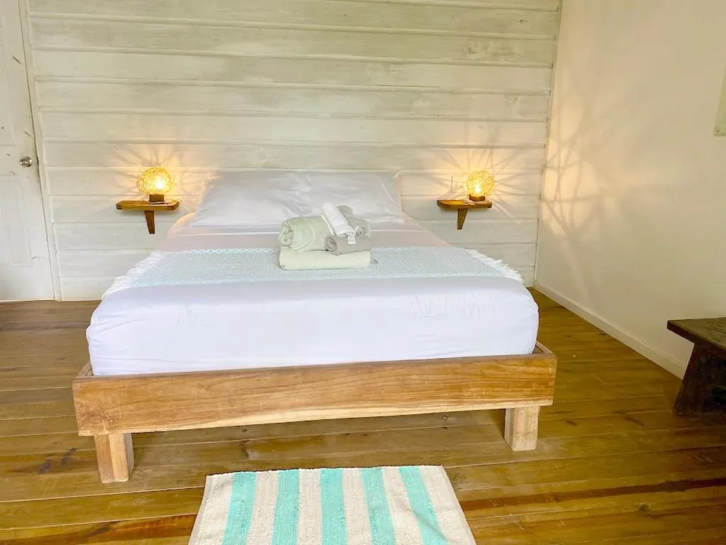 Bed in Bird Island Bungalows