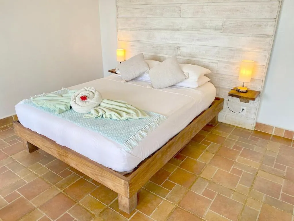Bed in Bird Island Bungalows