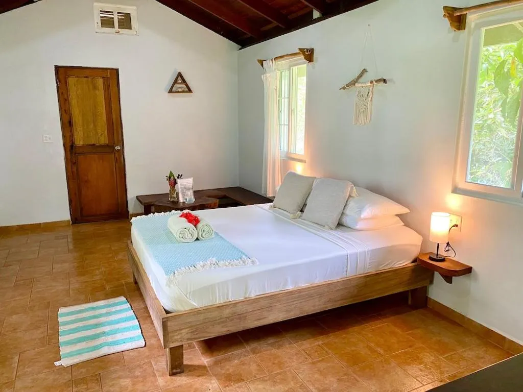 Bed in Bird Island Bungalows