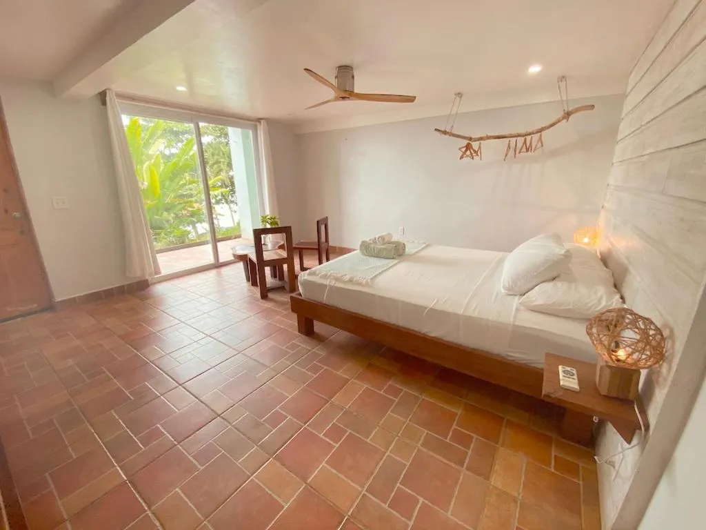 Photo of the whole room, Bed in Bird Island Bungalows