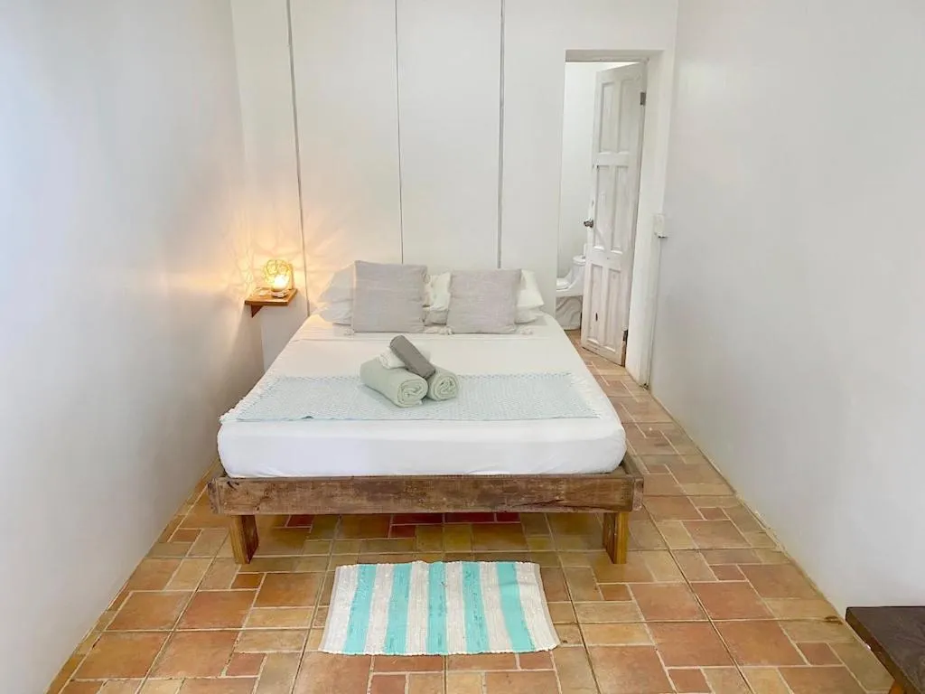 Bed in Bird Island Bungalows