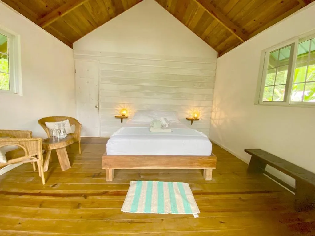 Bed in Bird Island Bungalows