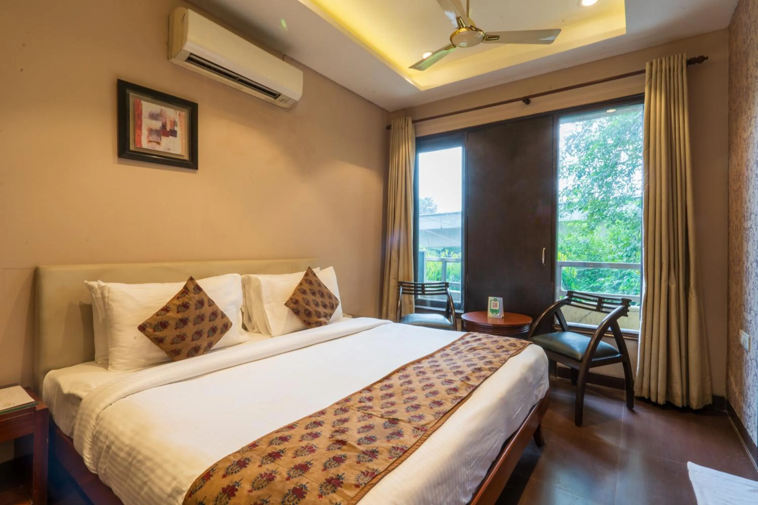Photo of the whole room, Bed in Cosy Grand, Chanakyapuri by The Cosy Hotels