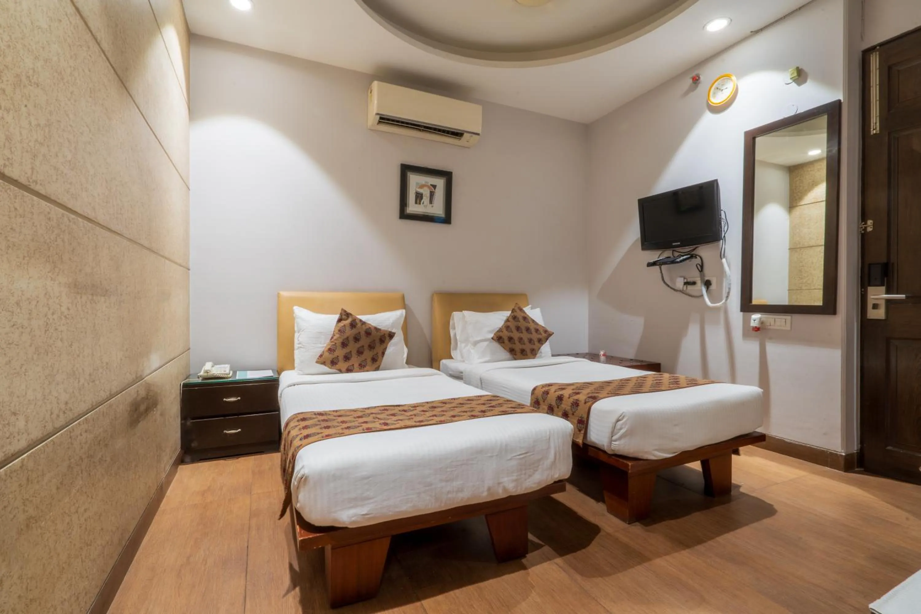 Bed in Cosy Grand, Chanakyapuri by The Cosy Hotels
