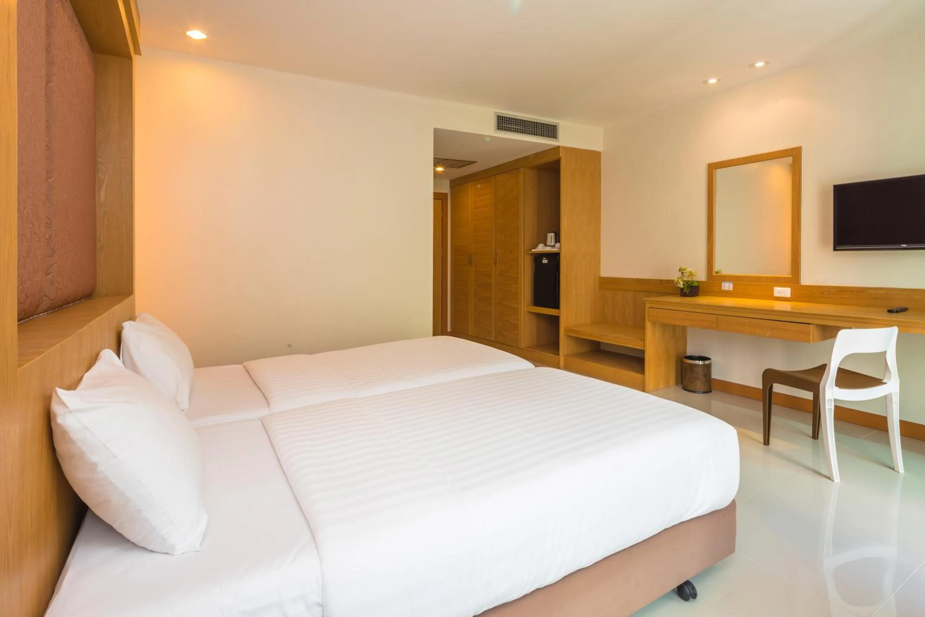 Bed in Sungthong Kamala Beach Resort