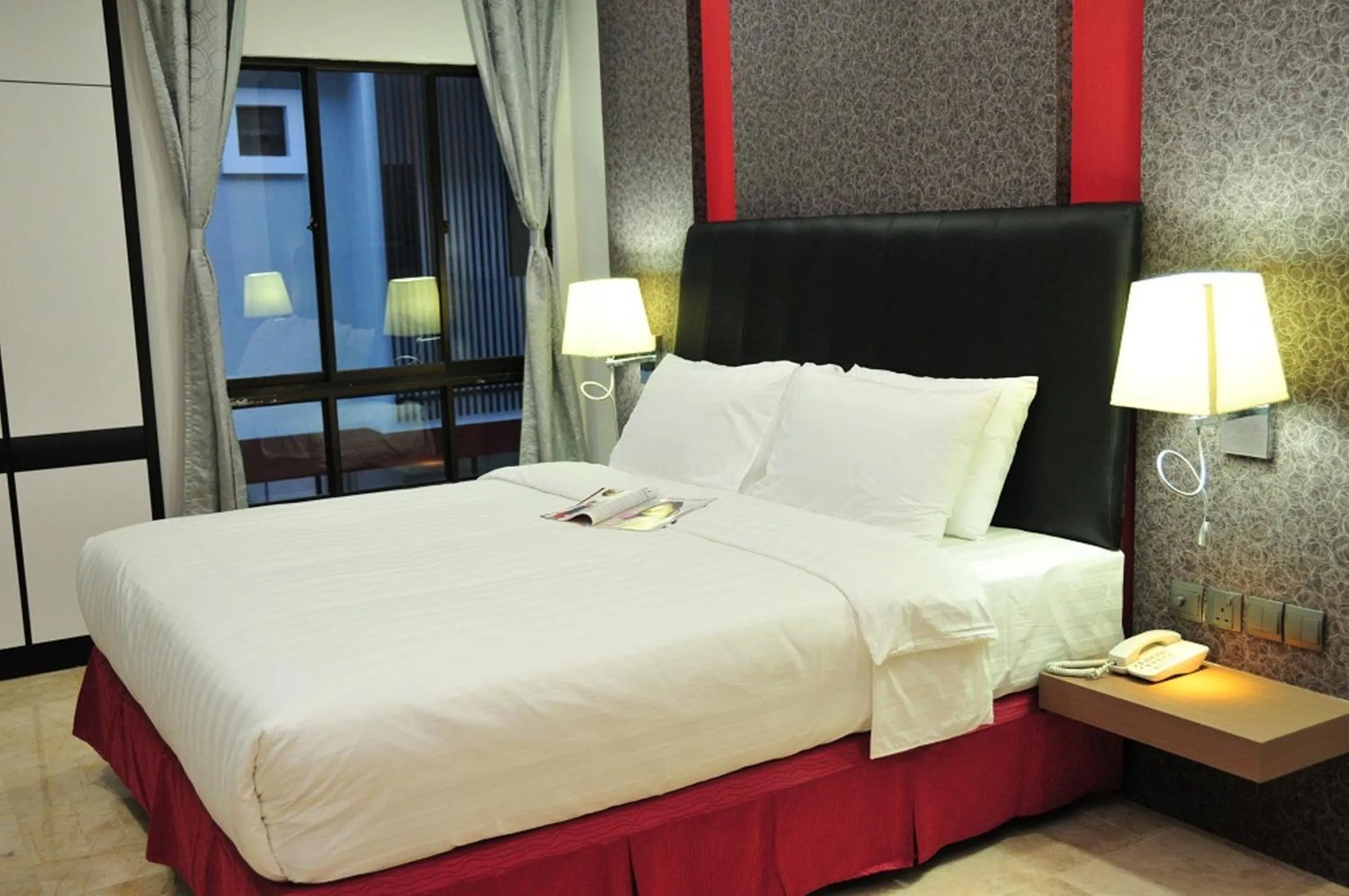 Bed in The Centro Hotel & Residence By Orchardz