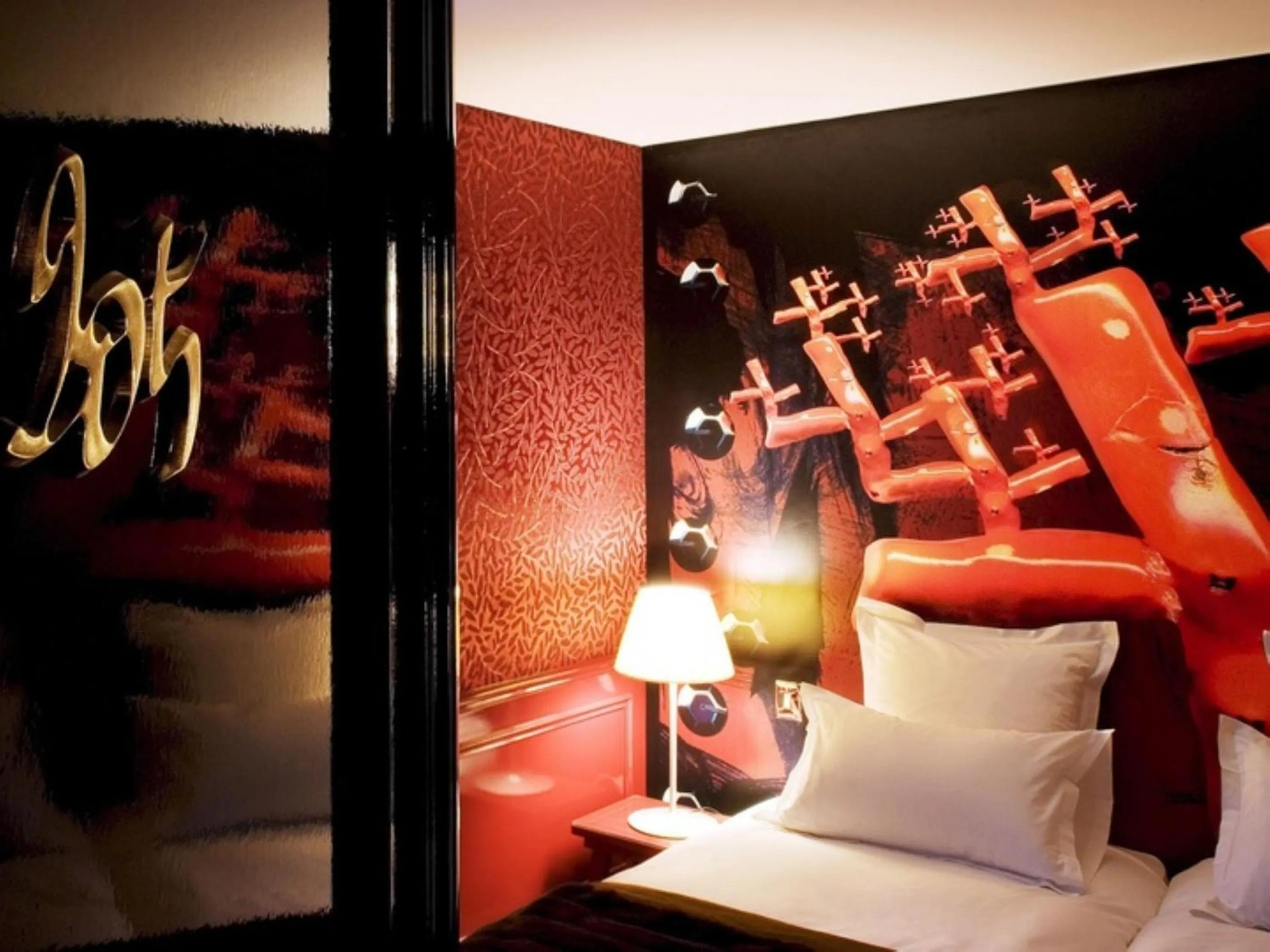 Bed in Hôtel du Petit Moulin, Haute Couture hotel by Lacroix