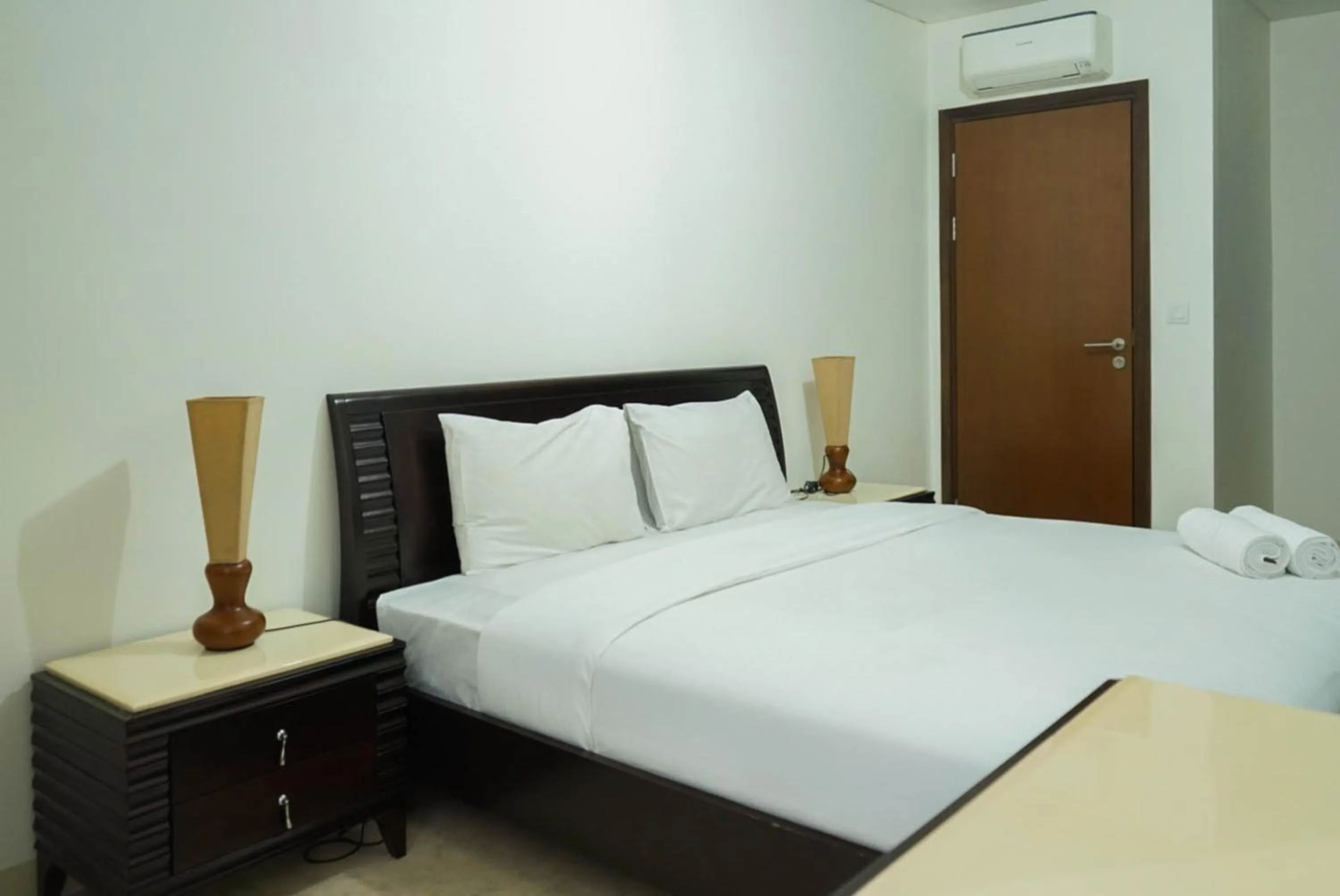 Bed in 2BR with Study Room at L'Avenue Apartment By Travelio