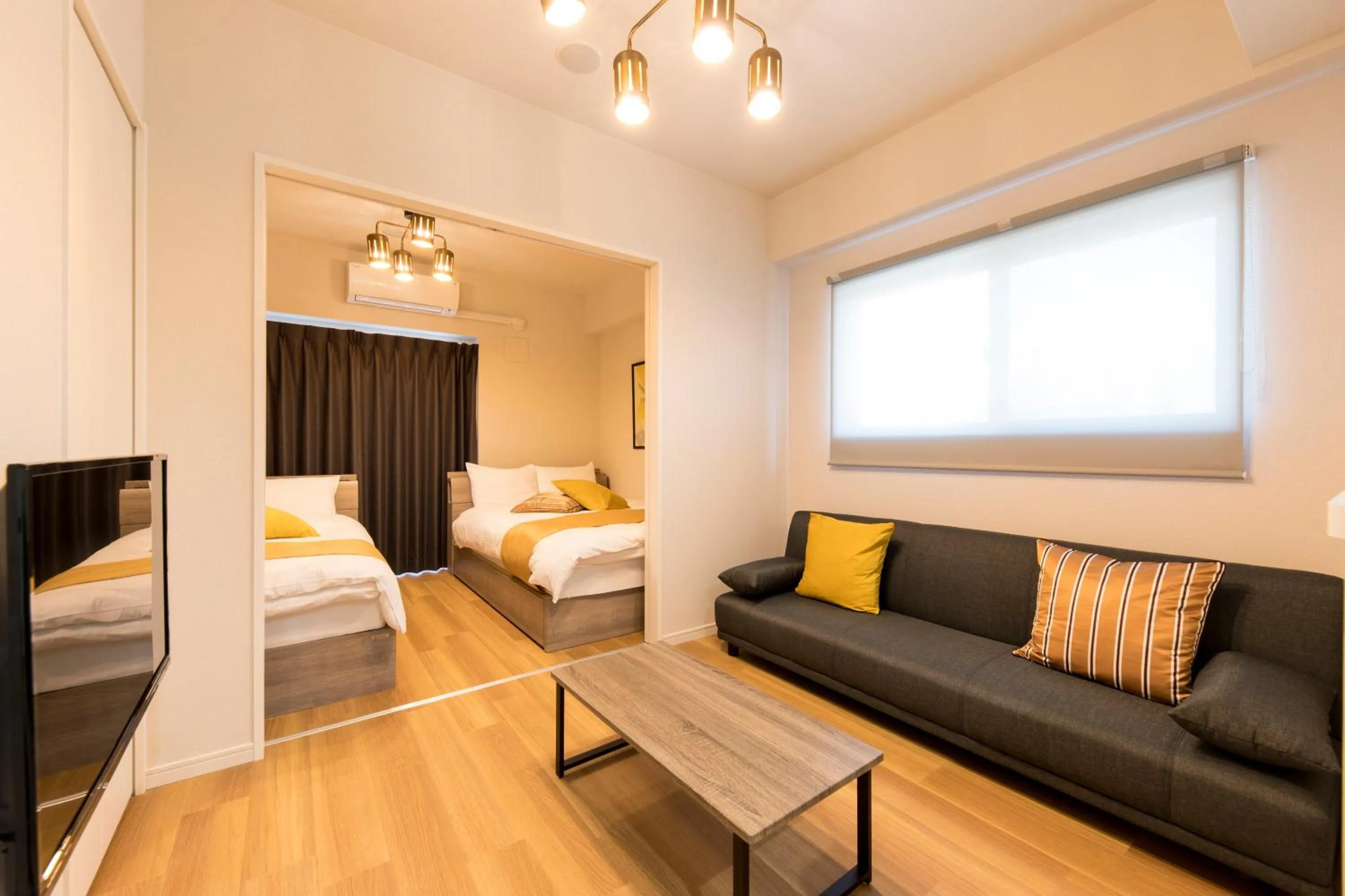 Living room, Bed in SG Residence Inn Hakataekiminami