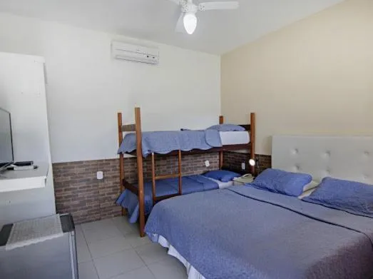 Bed in Pousada Três Pescadores