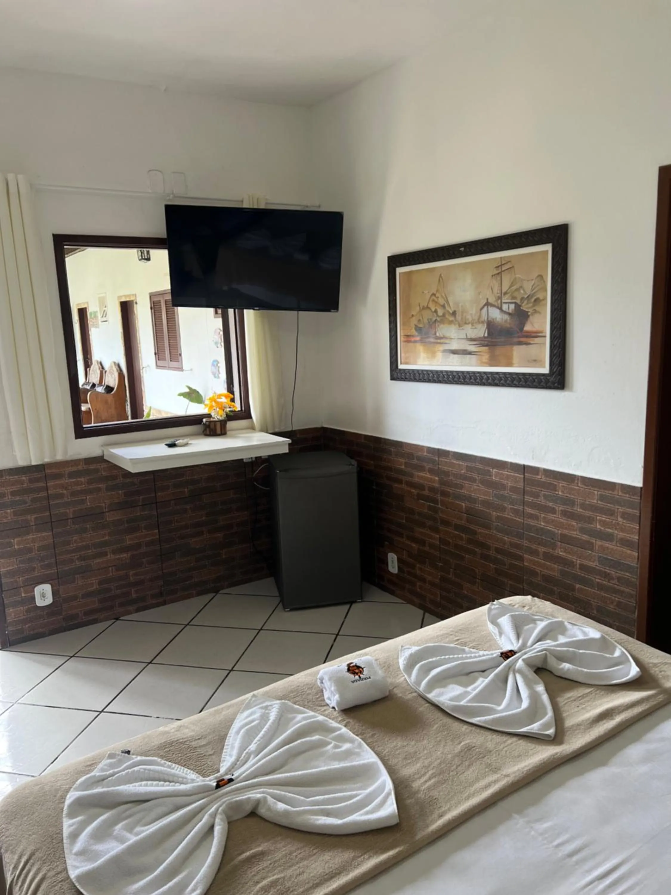 Bed in Pousada Três Pescadores