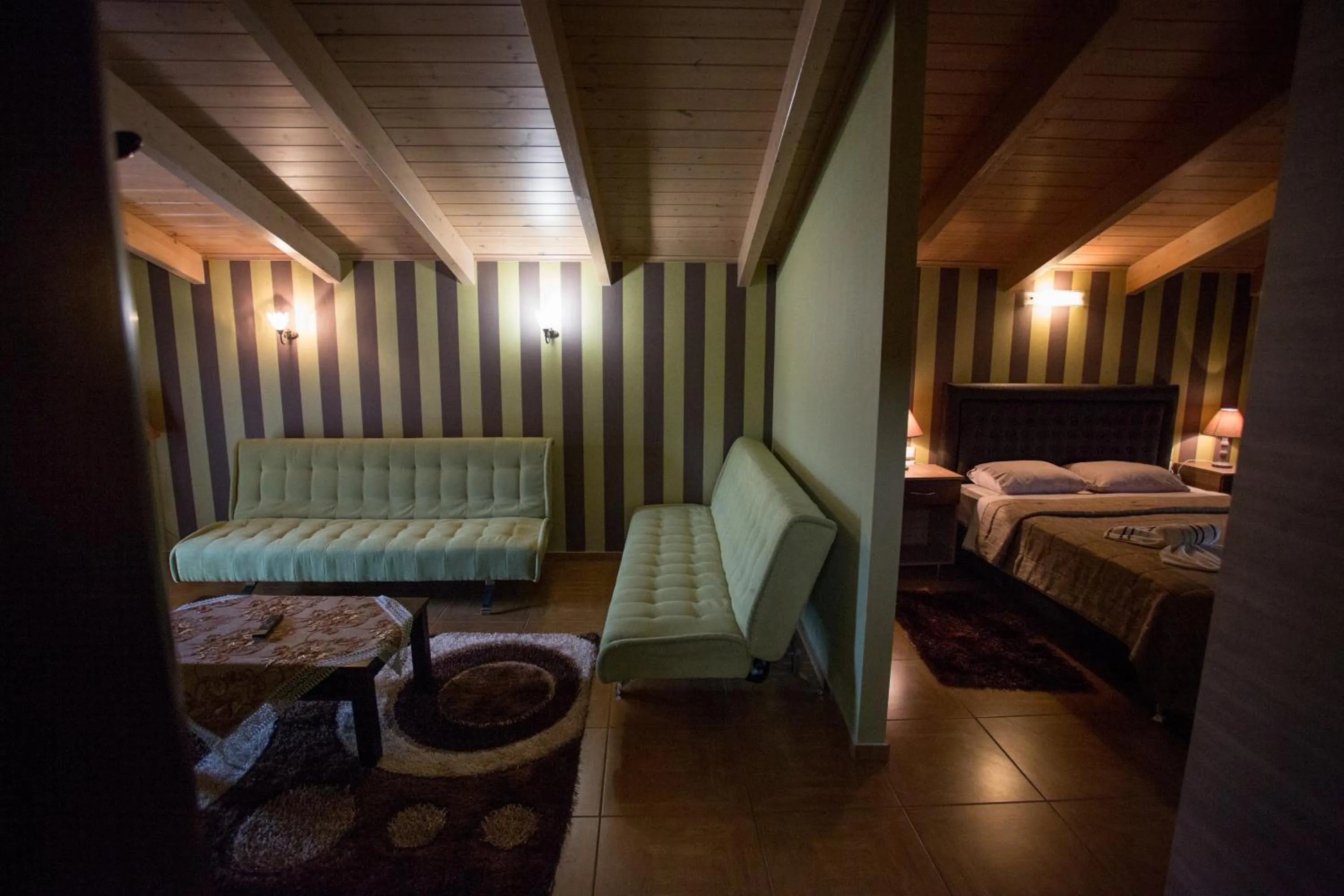 Living room, Bed in Delfini Hotel