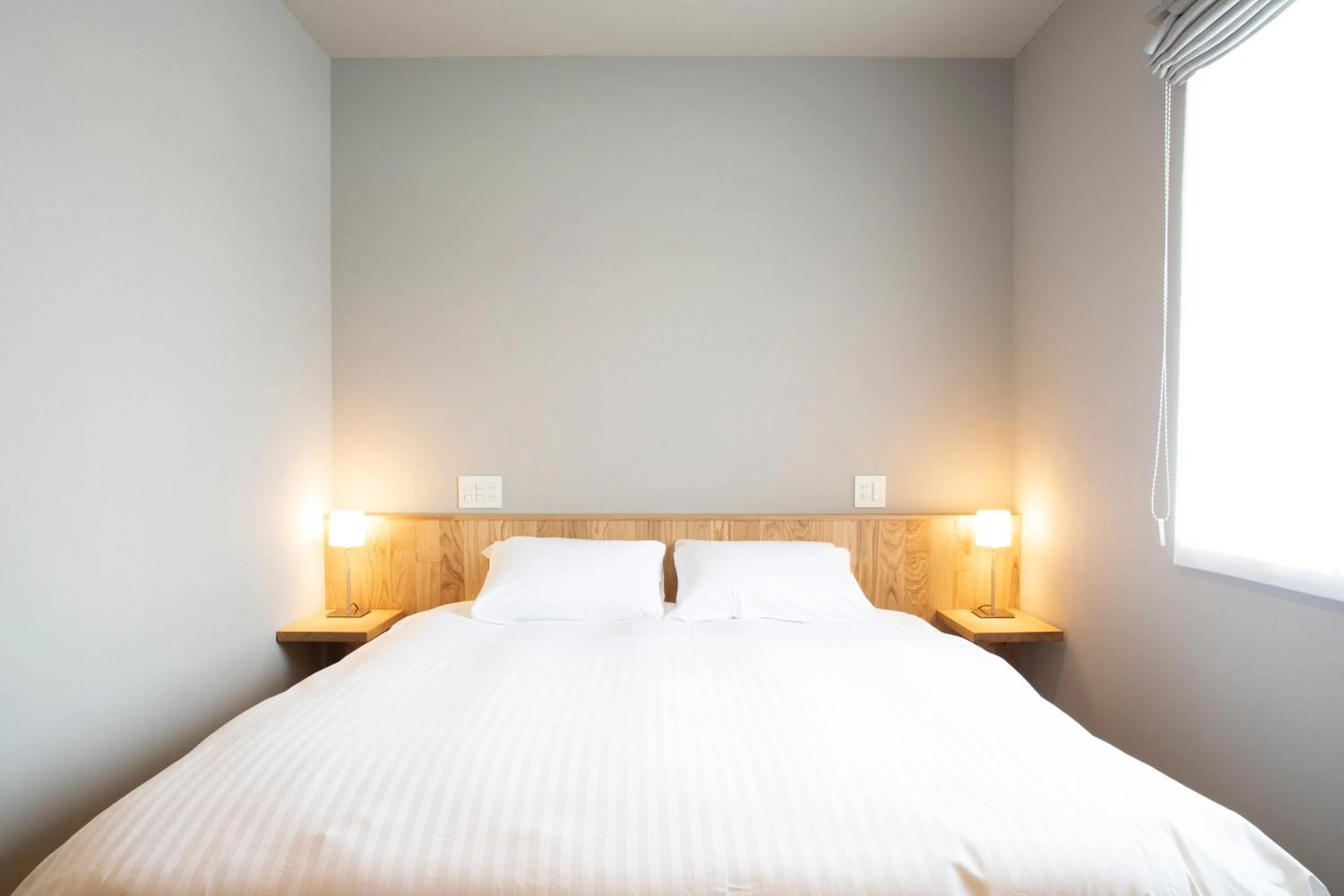 Bed in MASCOS HOTEL Masuda Onsen