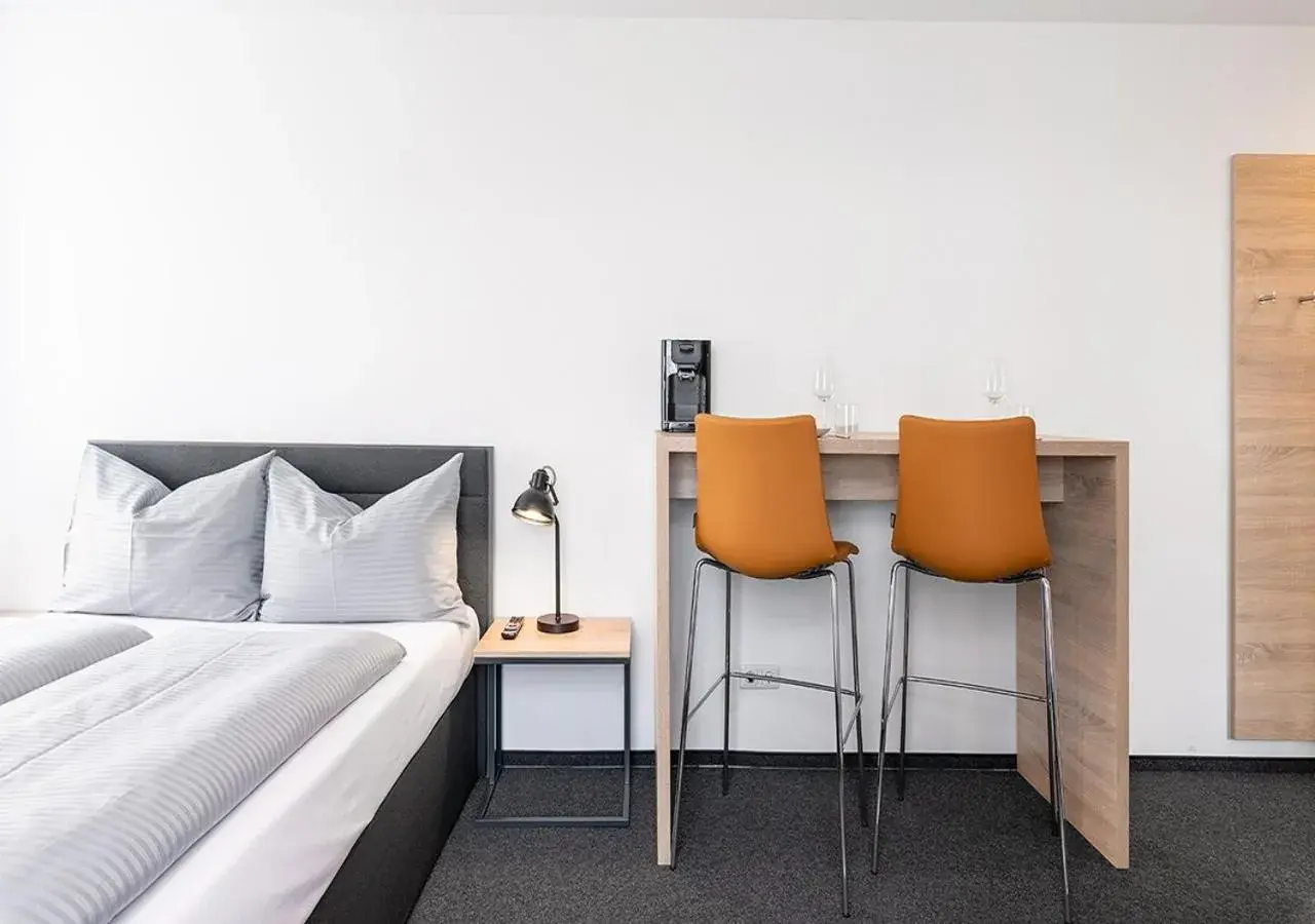 Seating area, Bed in Apartimo Landshut Seating area, Bed in Apartimo Landshut