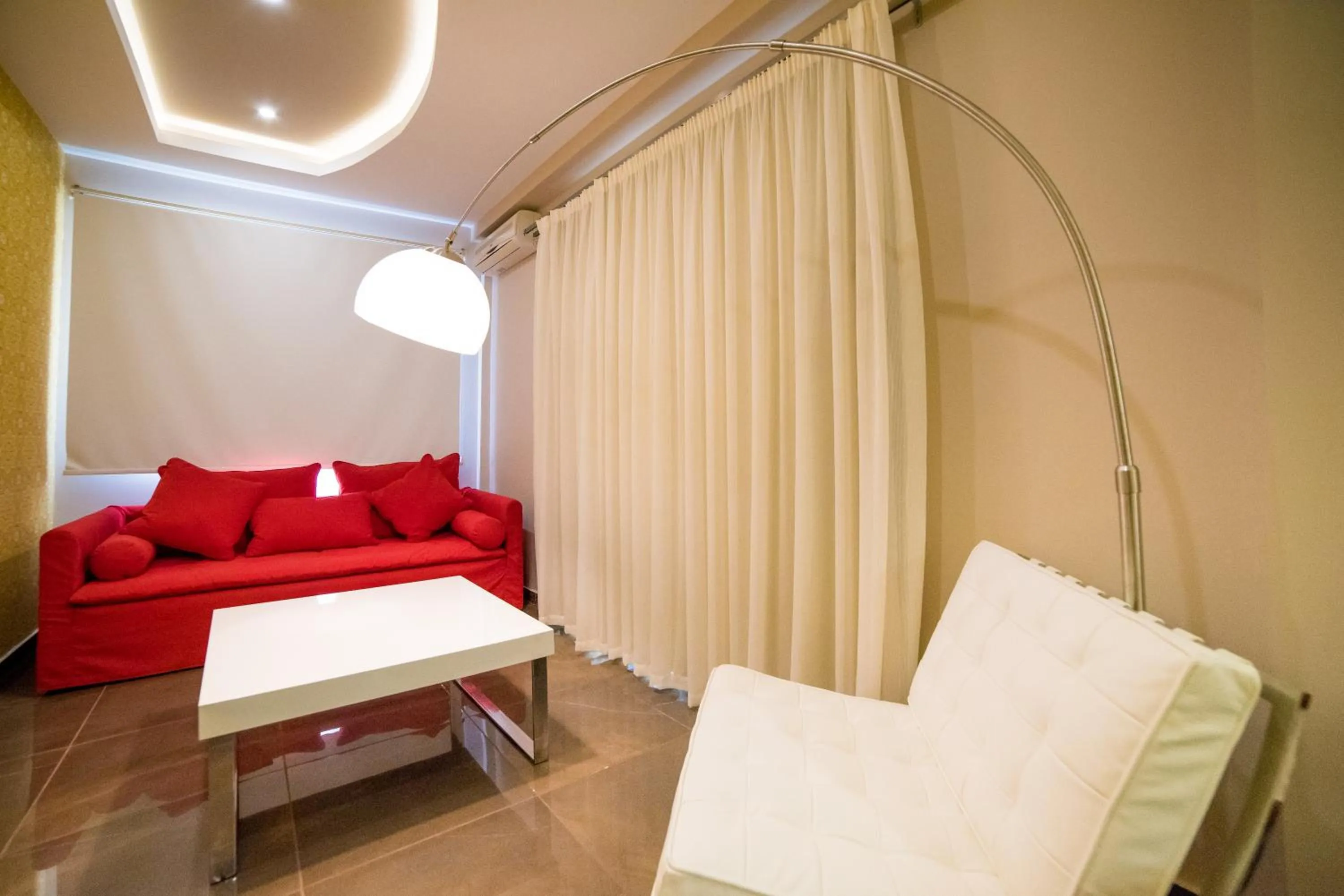 Living room, Bed in Koukounaria Hotel & Suites