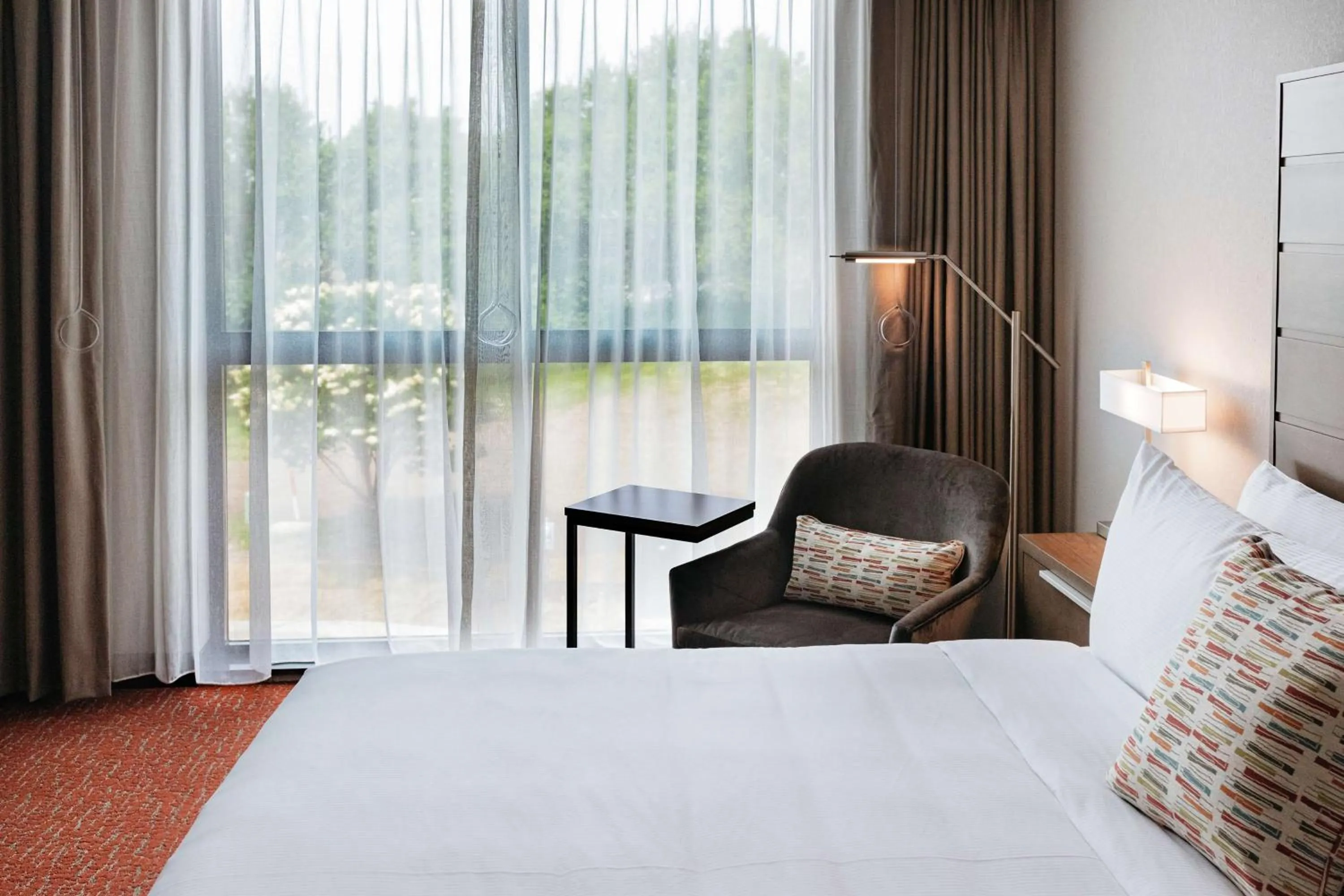 Living room, Bed in Revel Hotel, Tapestry Collection By Hilton