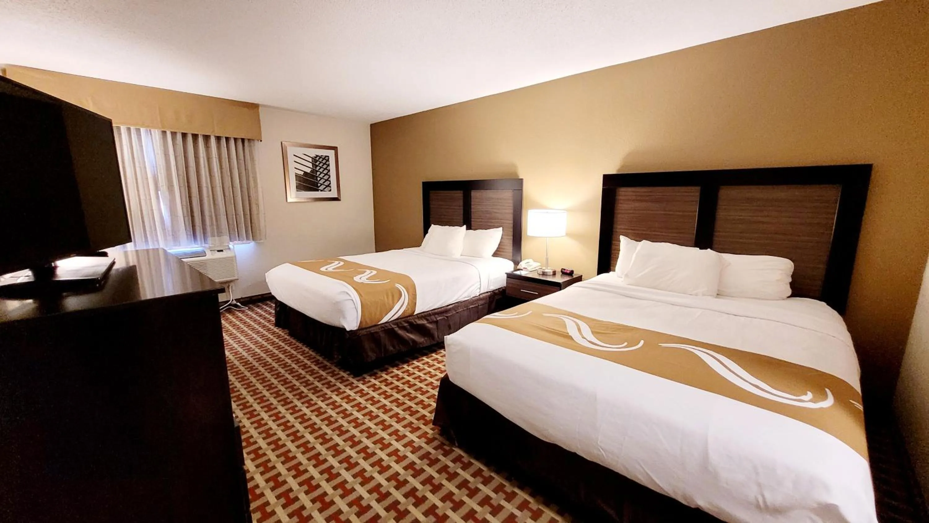 Bed in Quality Inn & Suites