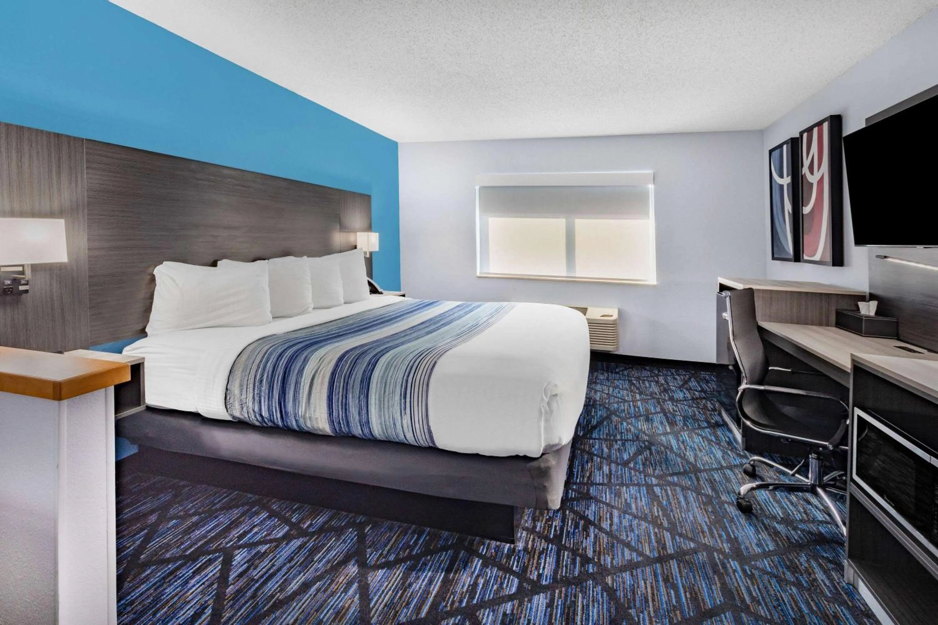 Bed in AmericInn by Wyndham Quincy