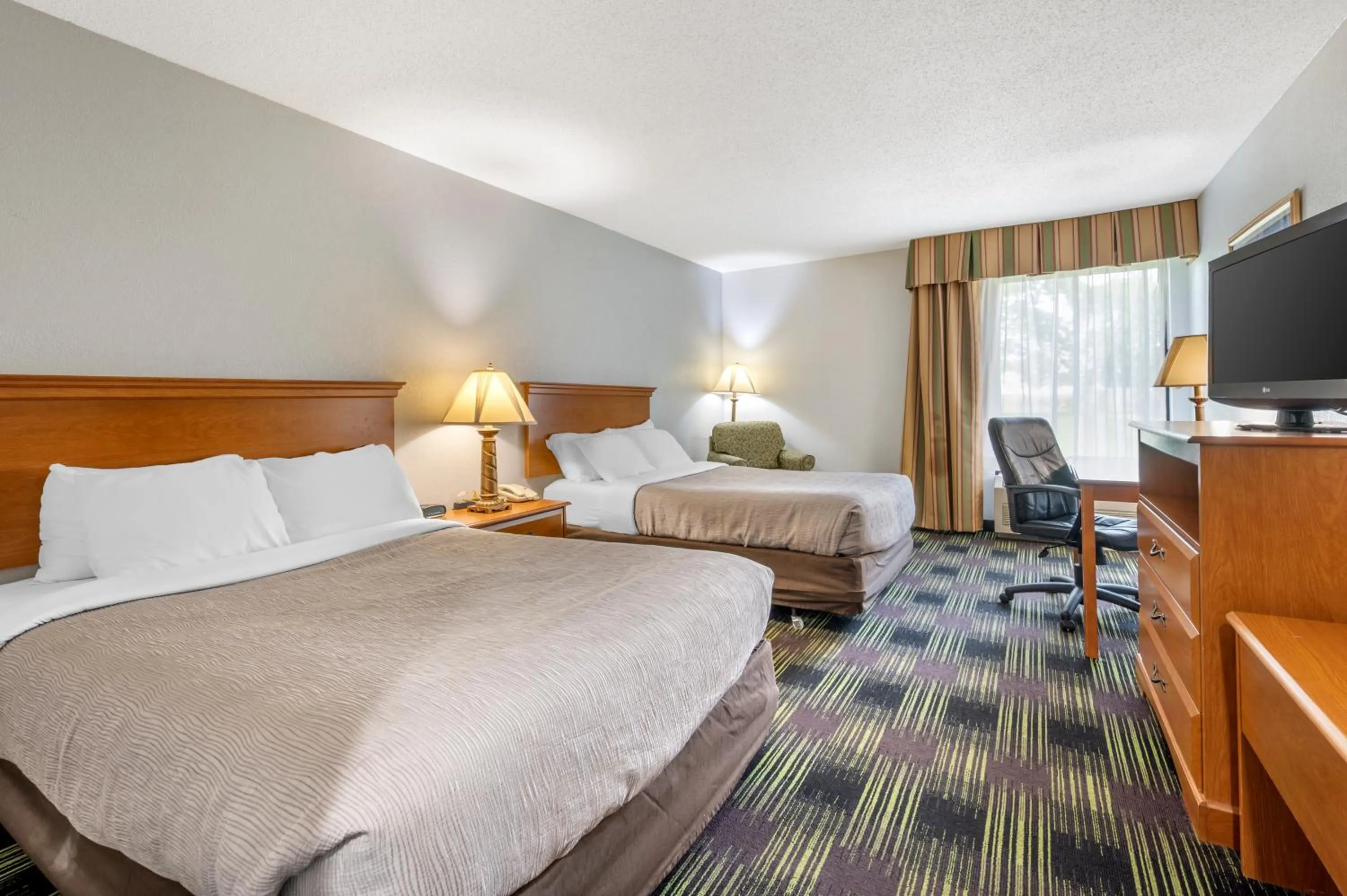 Bed in Quality Inn & Suites Near Amish Country