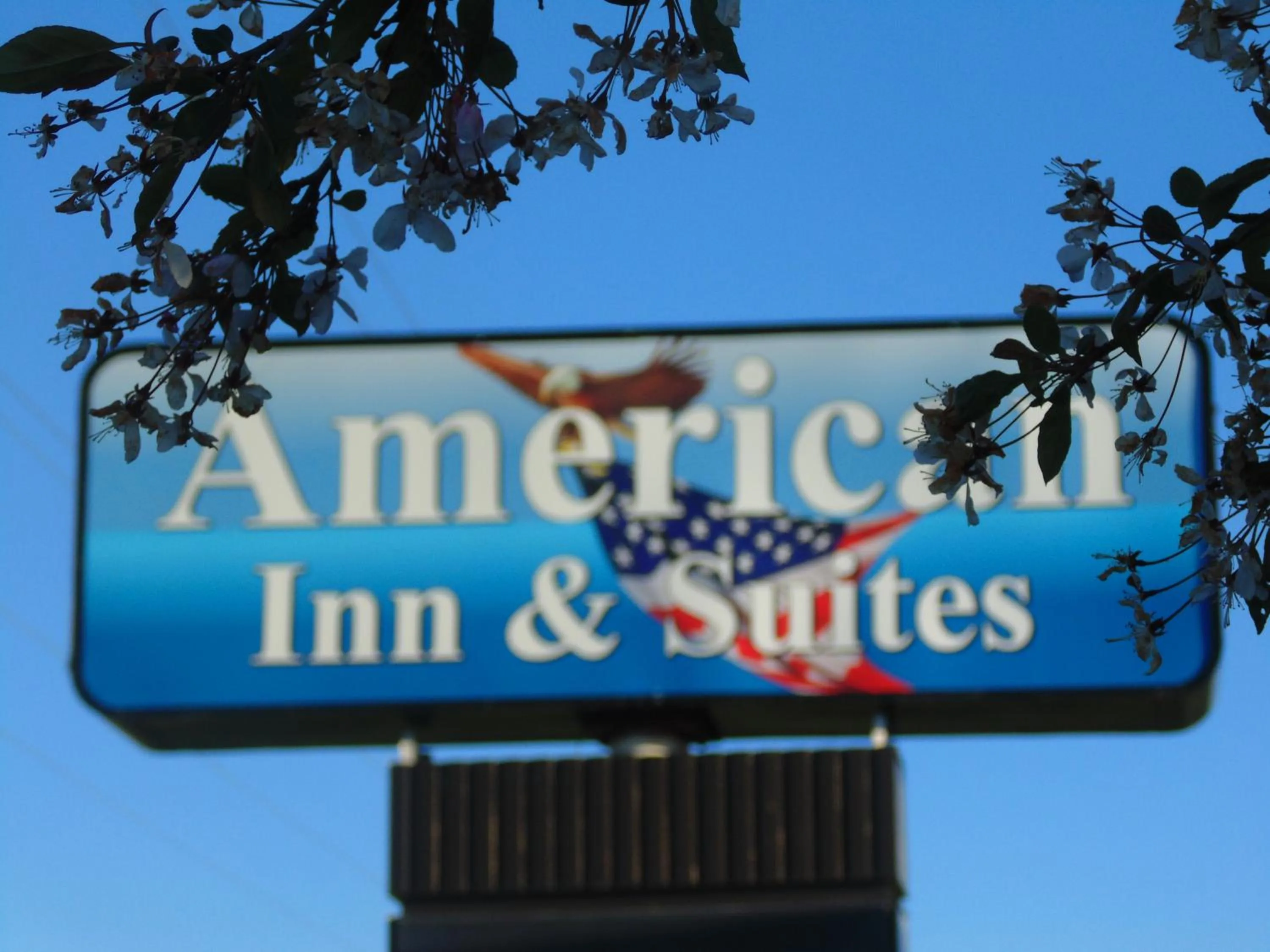 Property logo or sign in American Inn and Suites Houghton Lake