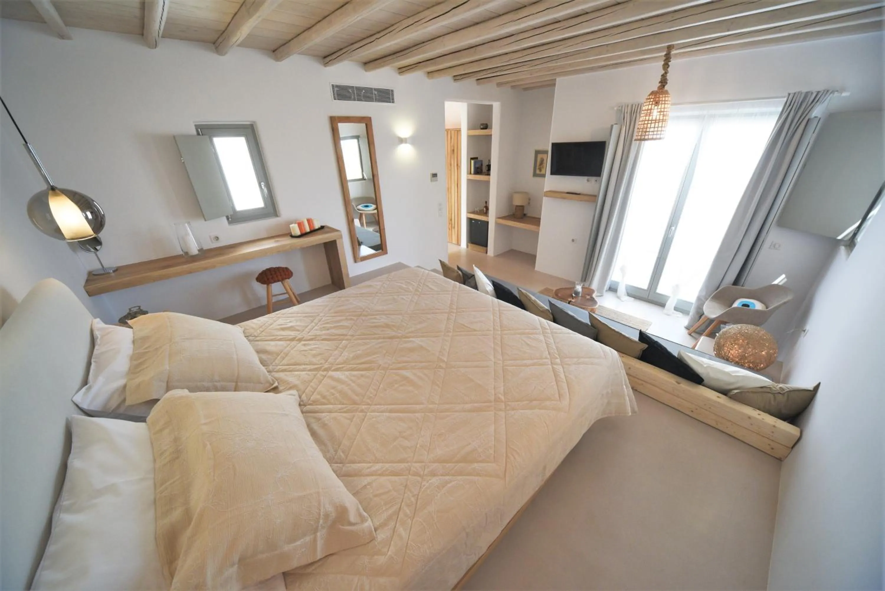 Bed in Myconian Crown Suites