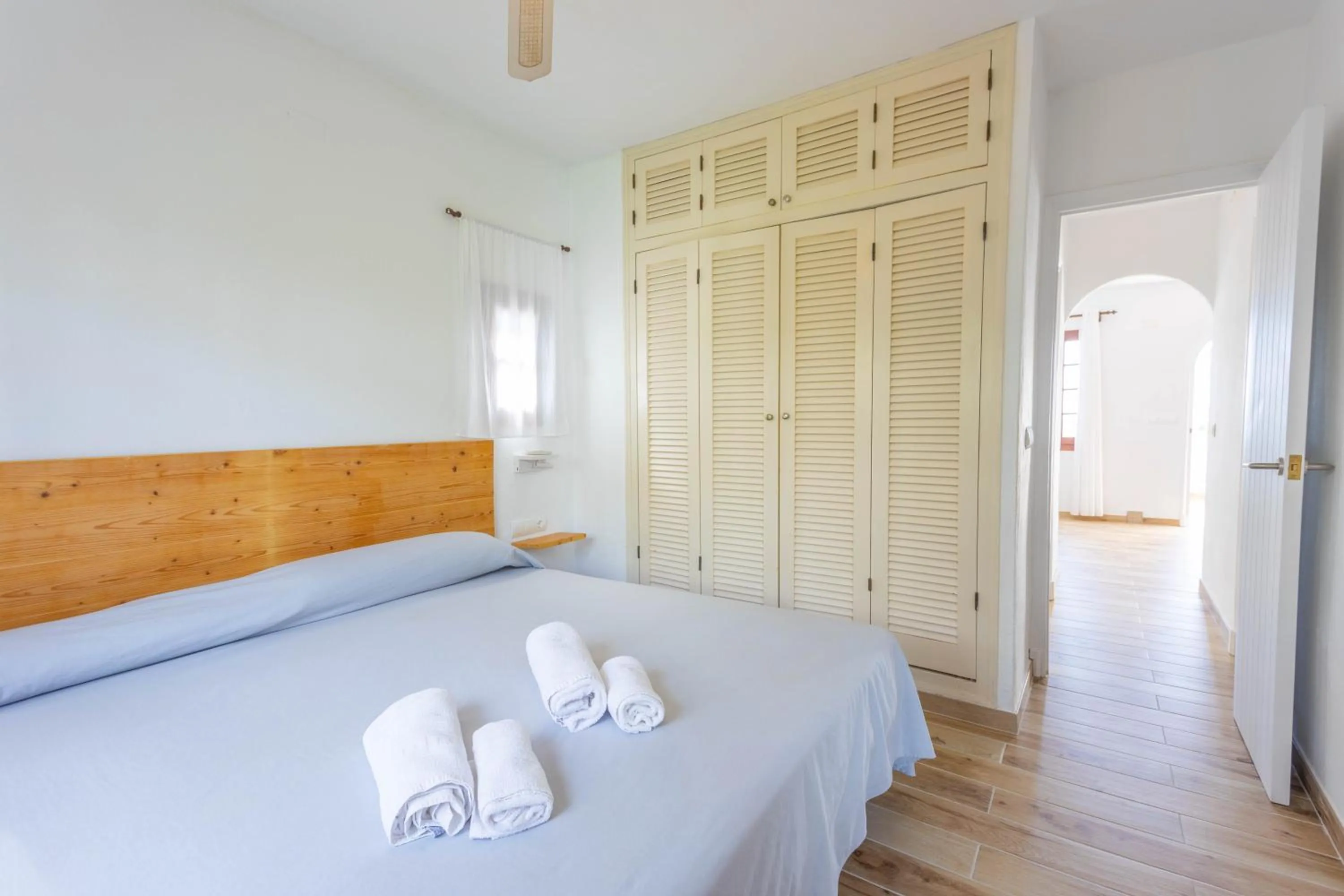 wardrobe, Bed in Apartamentos Son Bou Gardens By MENORCARENTALS