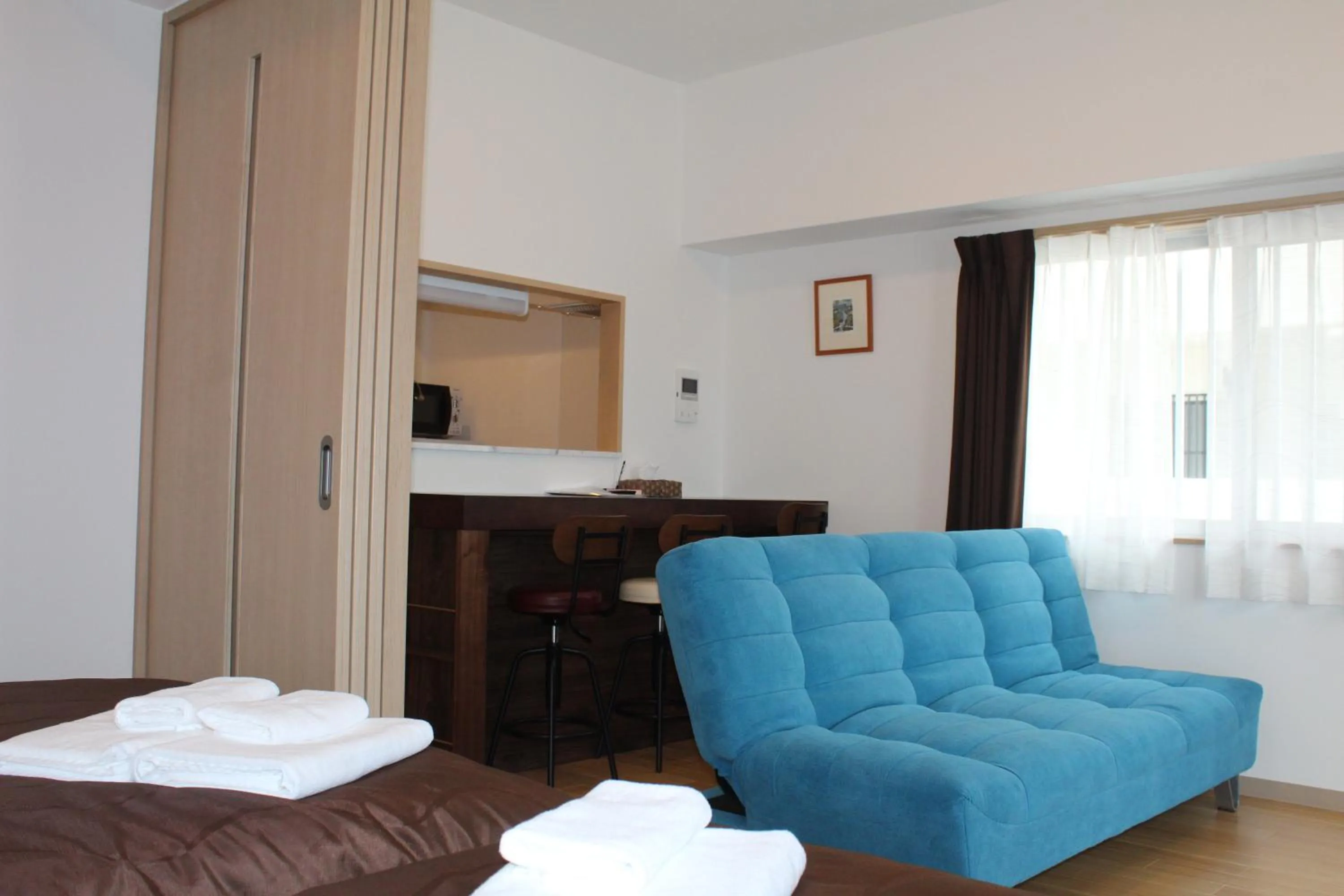 Photo of the whole room, Bed in M´s Stay Okinawa