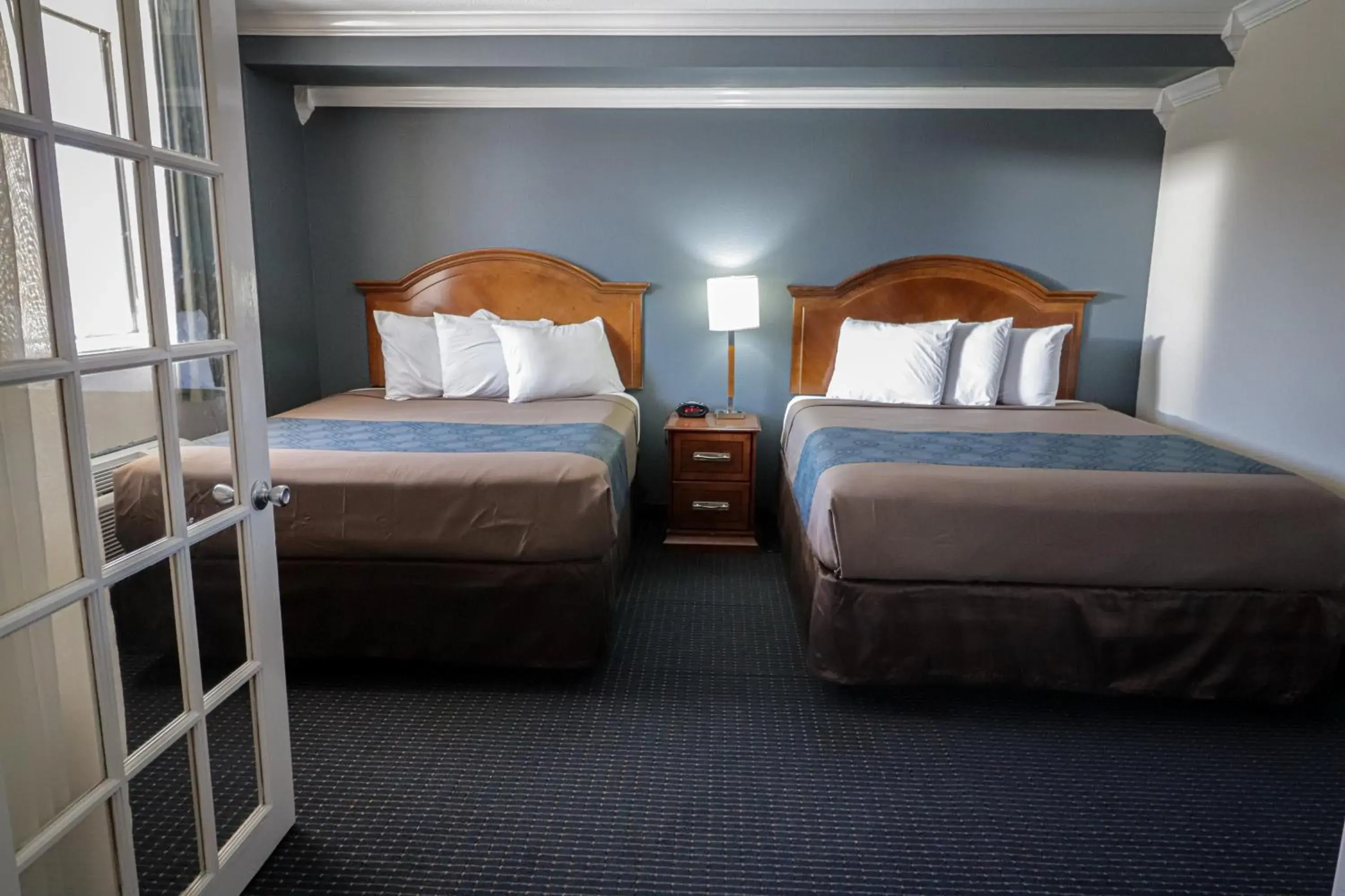 Bed in University Inn & Suites Bed in University Inn & Suites