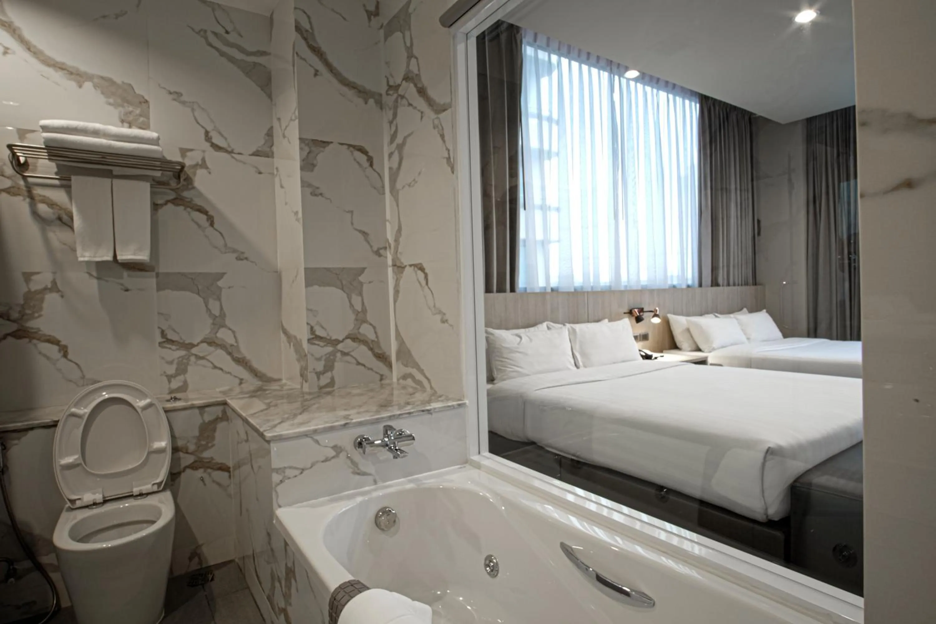 Bed in Gold Orchid Bangkok Hotel