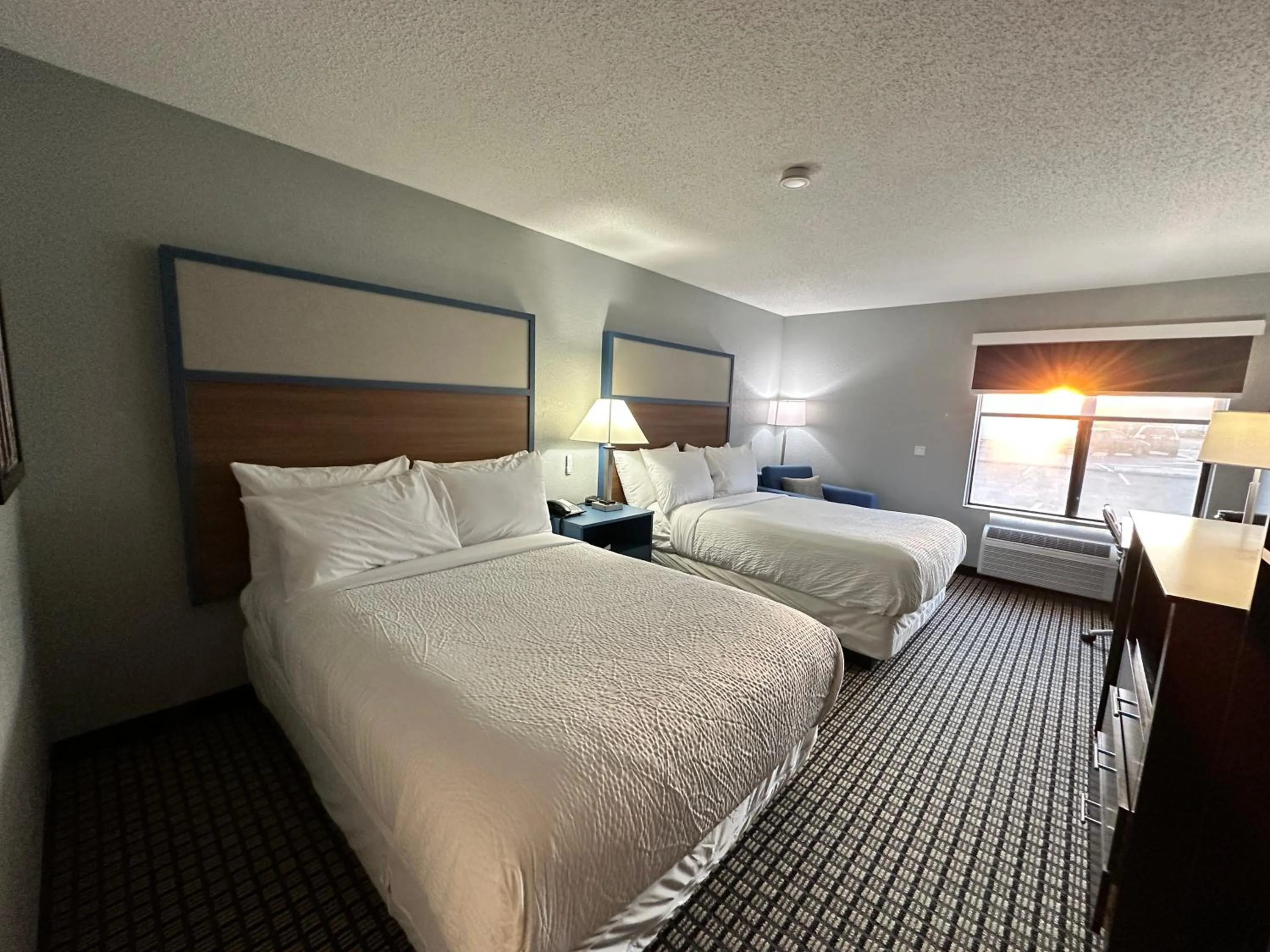Bed in AmericInn by Wyndham Reedsburg