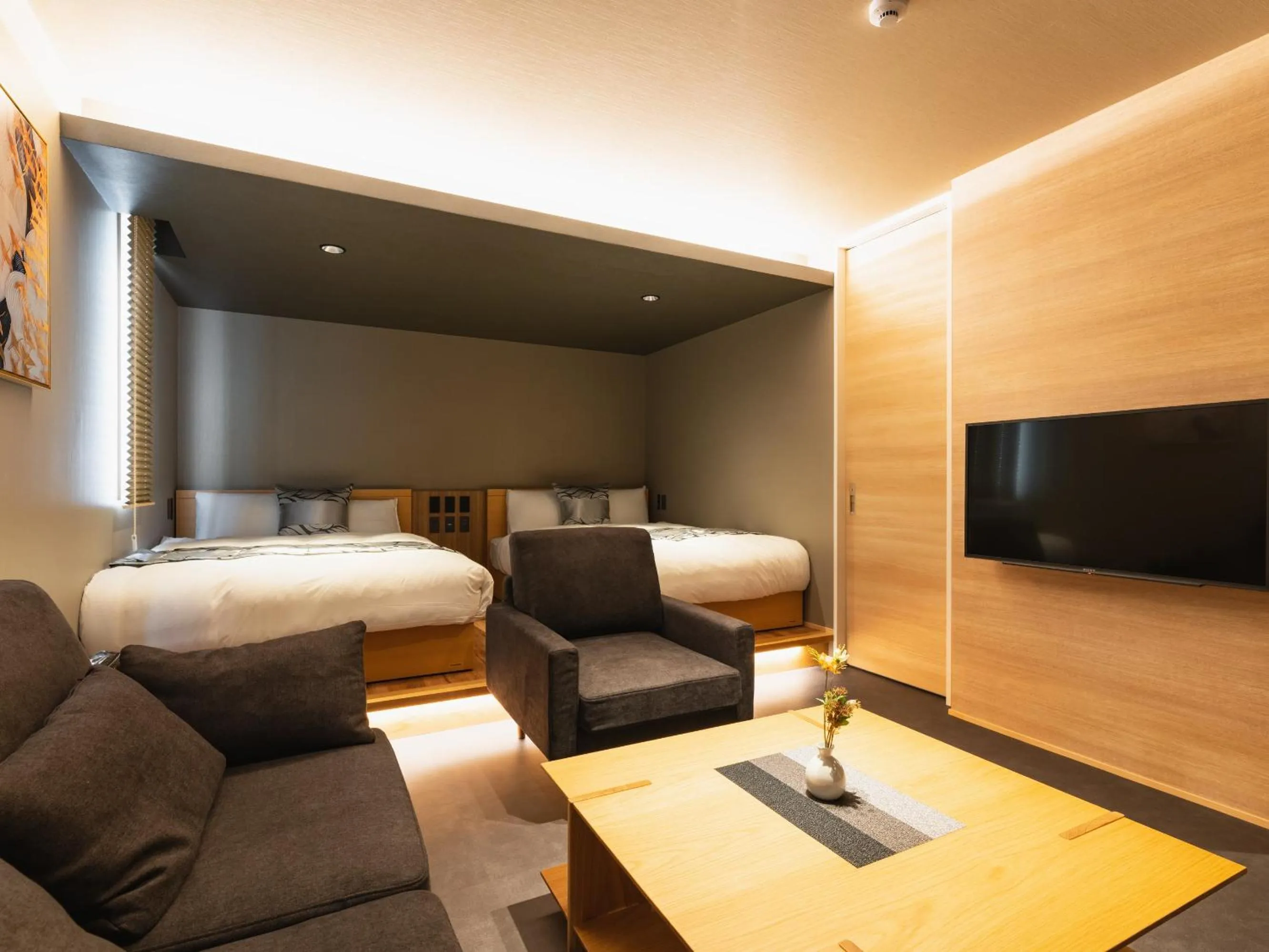 Living room, Bed in GRAND BASE Beppu Ekimae