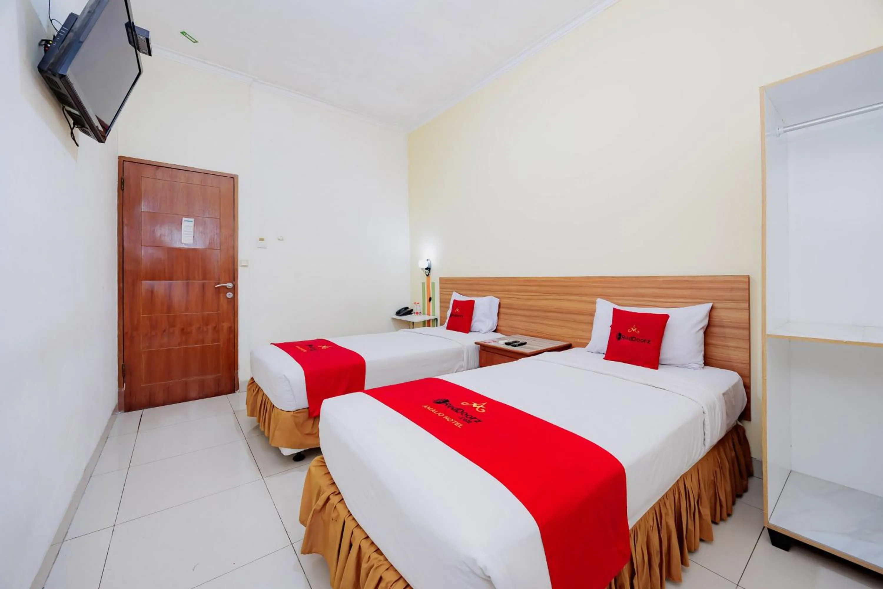 Bedroom, Bed in RedDoorz Plus at Amalio Hotel Surapati